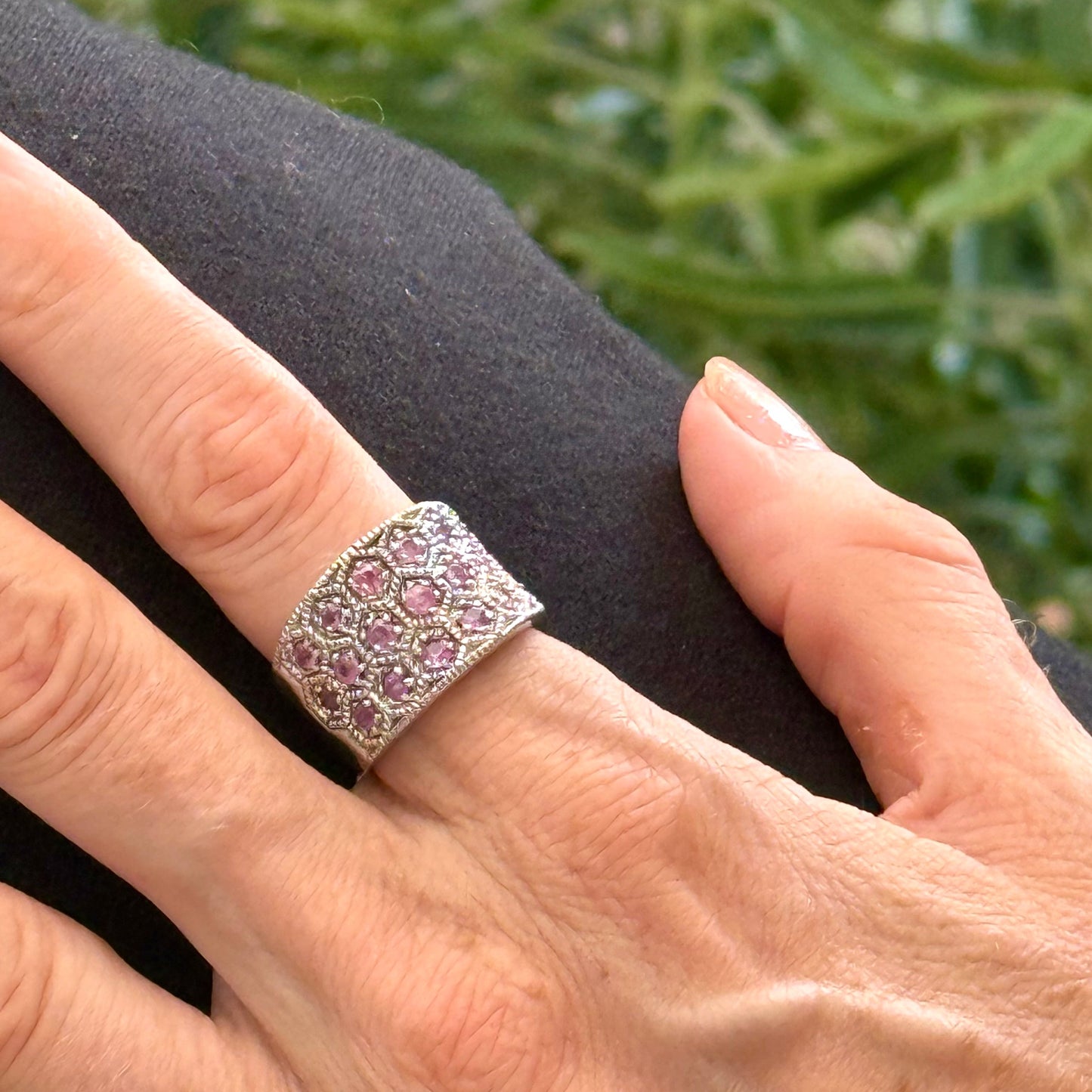 Ruby band ring in white gold plated sterling silver, featuring faceted natural red gemstones in a wide band design, elegant and luxurious style.