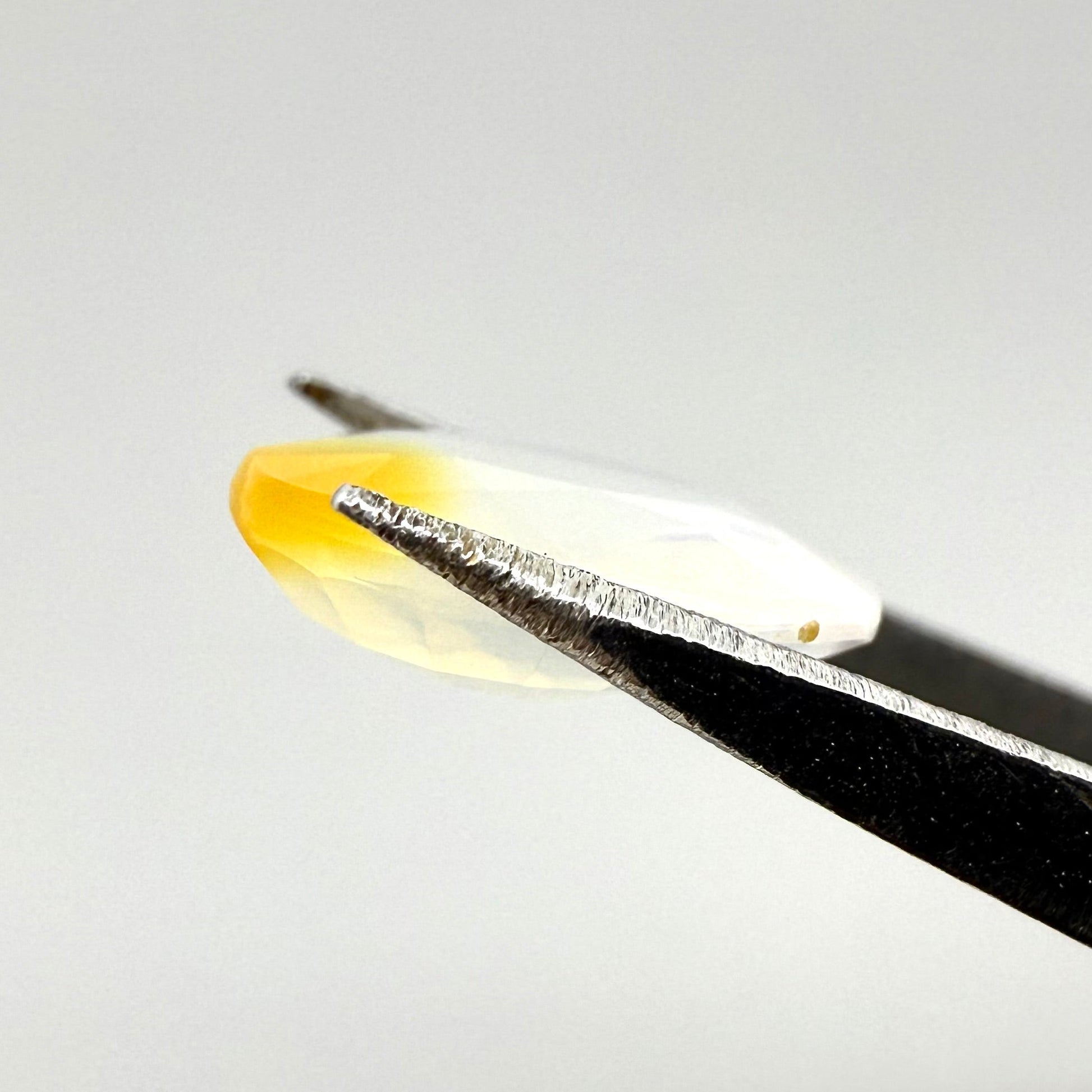 Natural Milky White with Orange Opal gemstone, oval cut