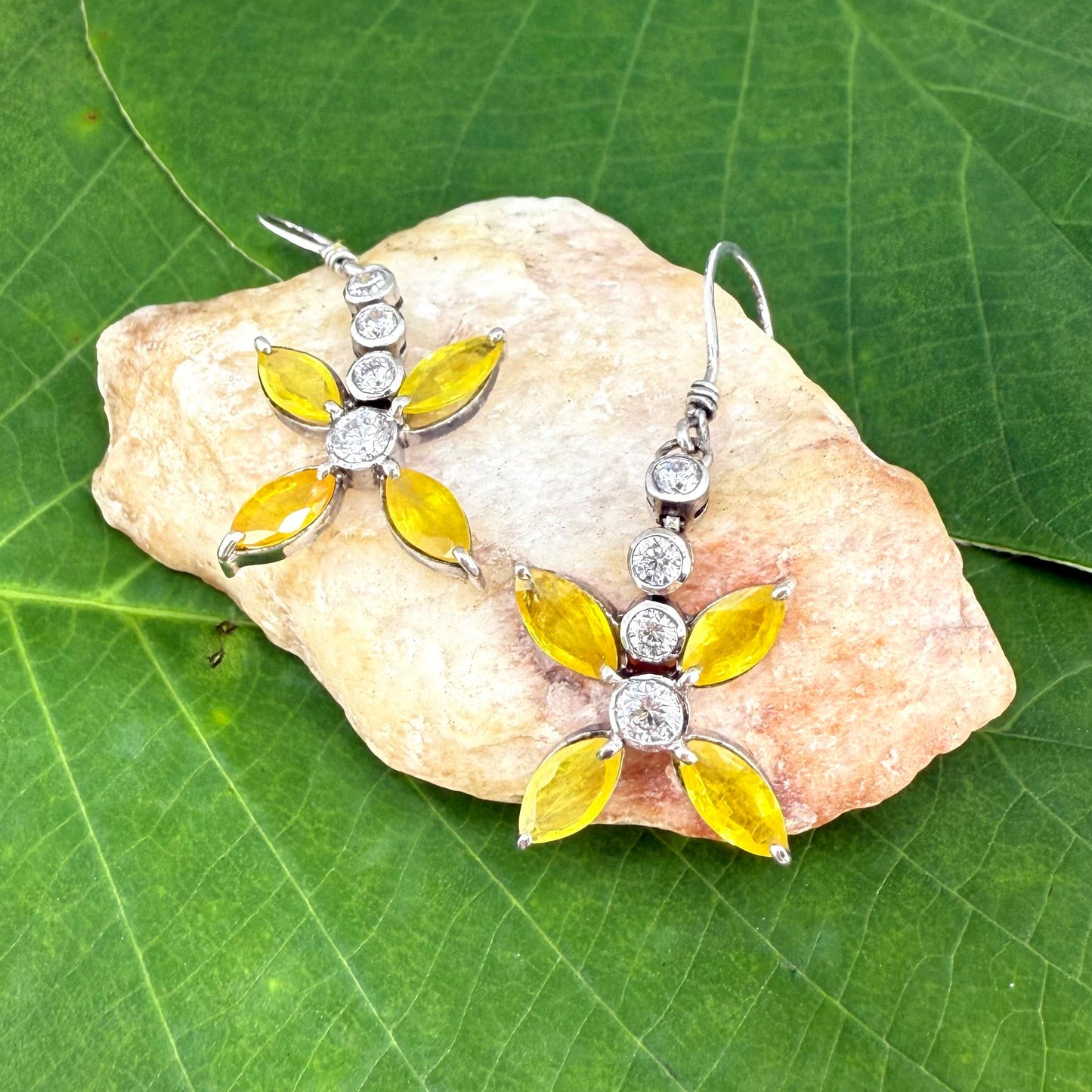 Sterling silver drop earrings with yellow sapphires and cubic zirconia in a floral design, linked to the Sapphire Jewelry Collection.