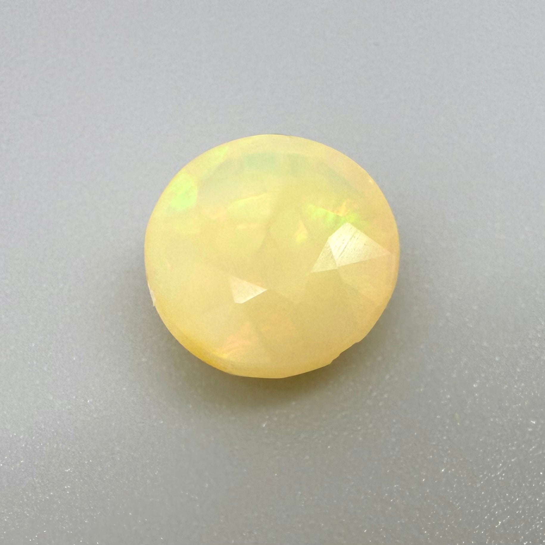 Natural Play-of-Color Fire Opal gemstone, round cut