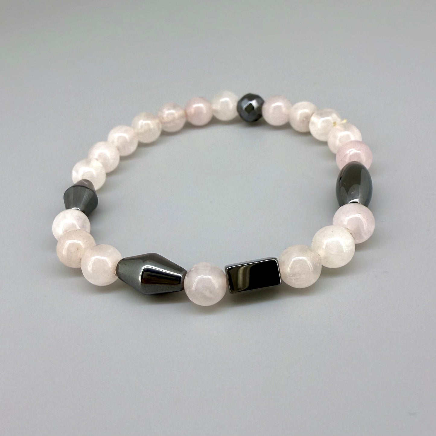 Rose quartz and hematite beaded bracelet, 18cm, soft pink gemstone beads with metallic hematite spacers on elastic stretch band.
