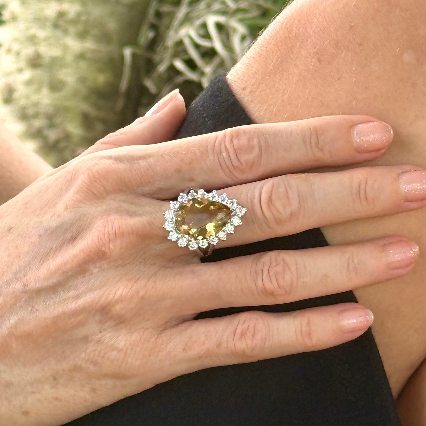 Citrine and CZ ring in white gold plated sterling silver, featuring a pear-shaped golden-yellow gemstone surrounded by clear cubic zirconia halo, elegant and refined design