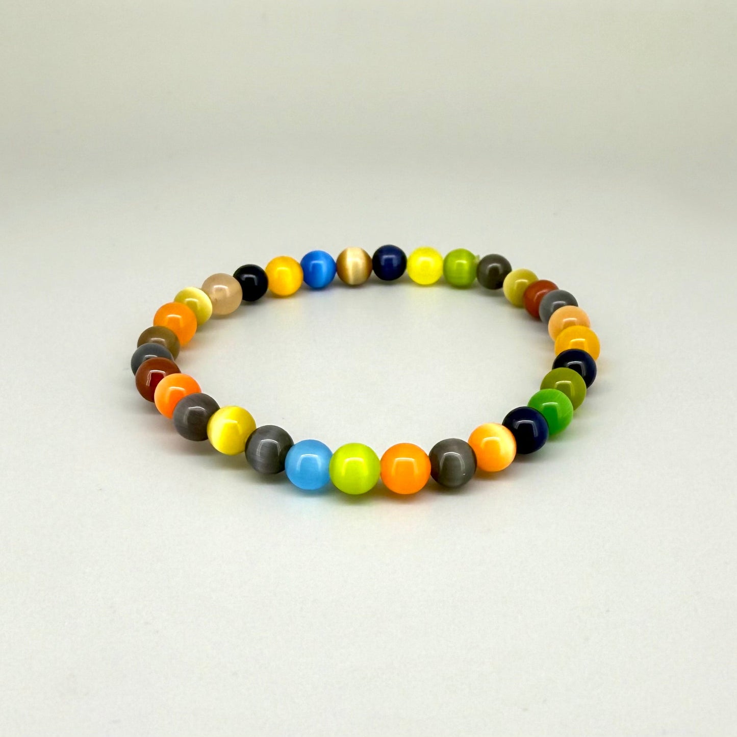 Multicolor cat’s eye beaded bracelet, 18cm, vivid gemstone beads in bright, brown, and black tones with shimmering effect on elastic stretch band.