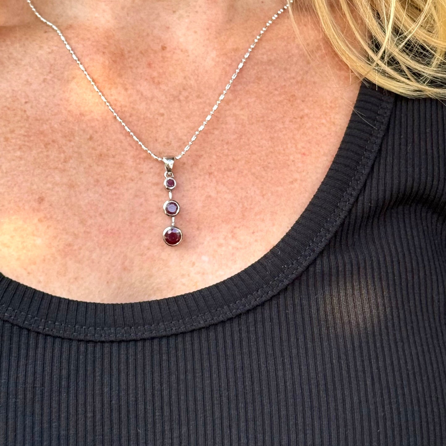Handcrafted pendant with three natural rubies (2.92 ct total) set vertically in white-gold-plated sterling silver.