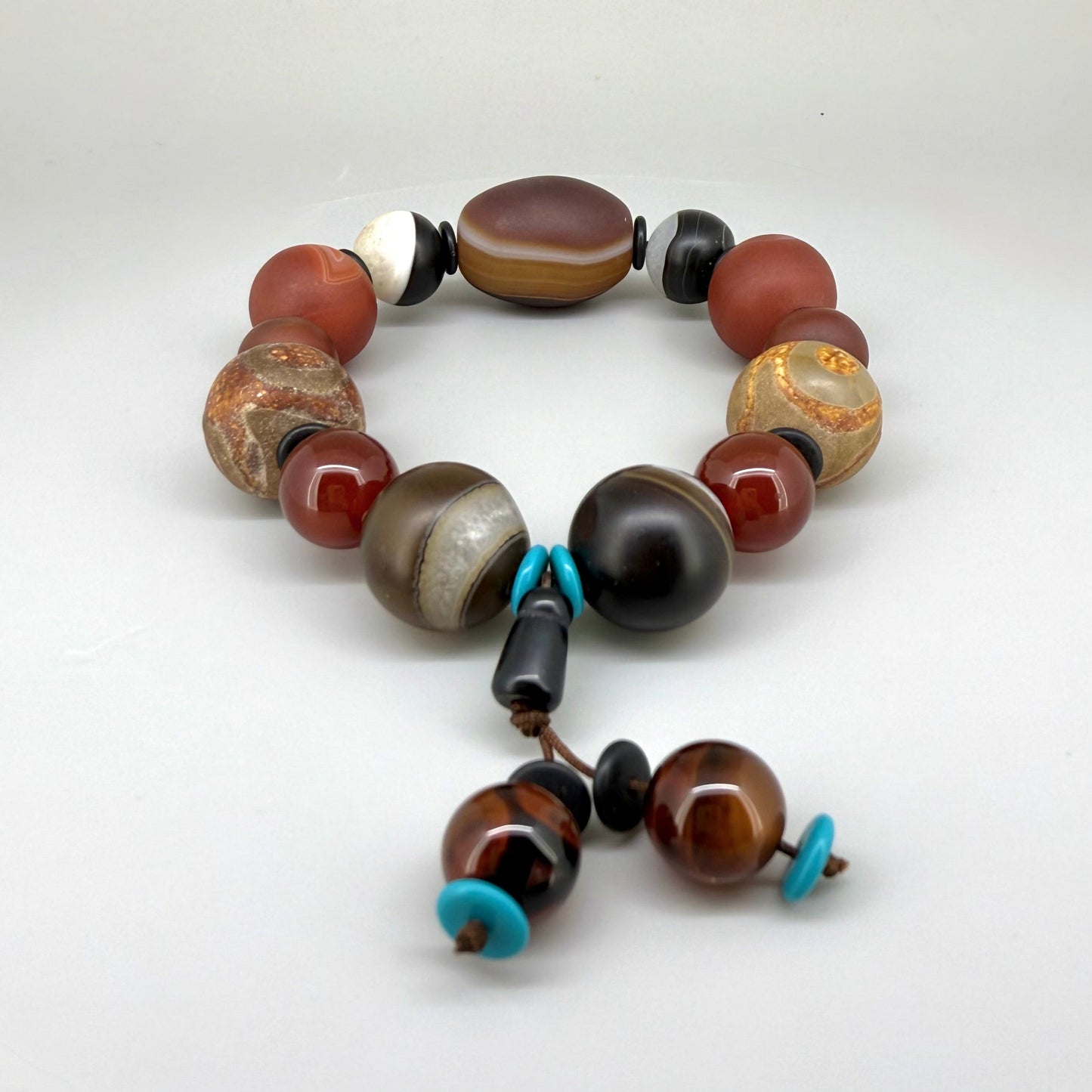 Agate and carnelian beaded bracelet, 20cm, with fiery red, brown, and colorful accent beads on elastic stretch band.