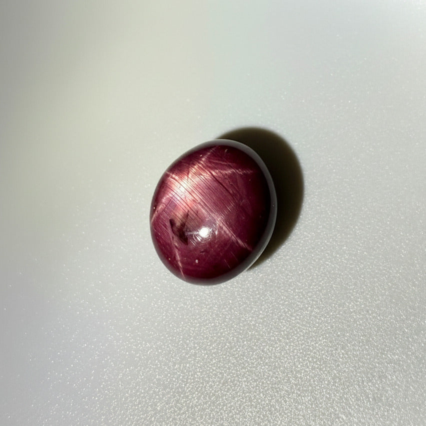 23.7 ct natural Bordeaux-Red Star Ruby cabochon from Mozambique with a clearly defined star and polished dome.
