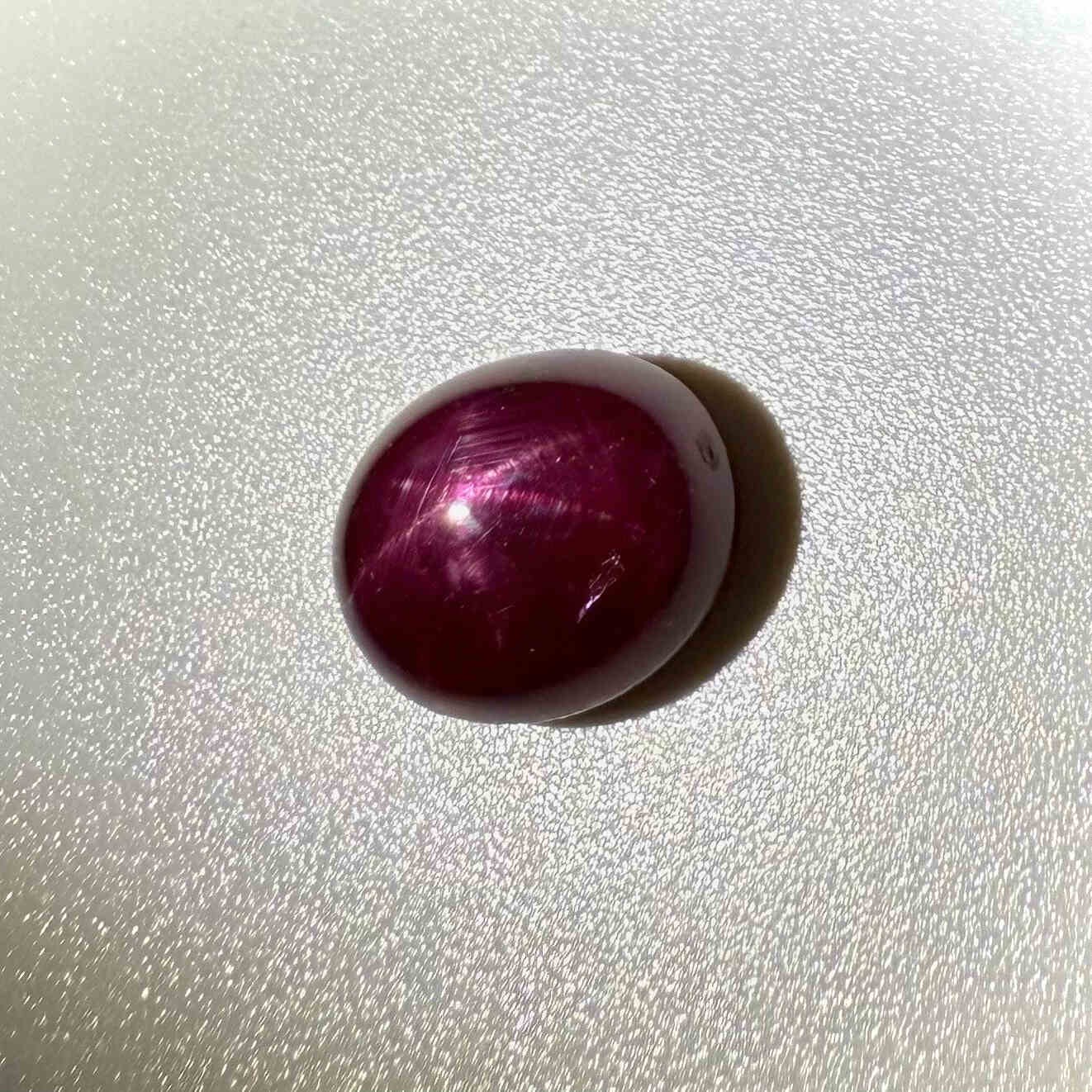 13.5 ct natural Pink-Red Star Ruby cabochon from Mozambique with soft star effect and polished dome.