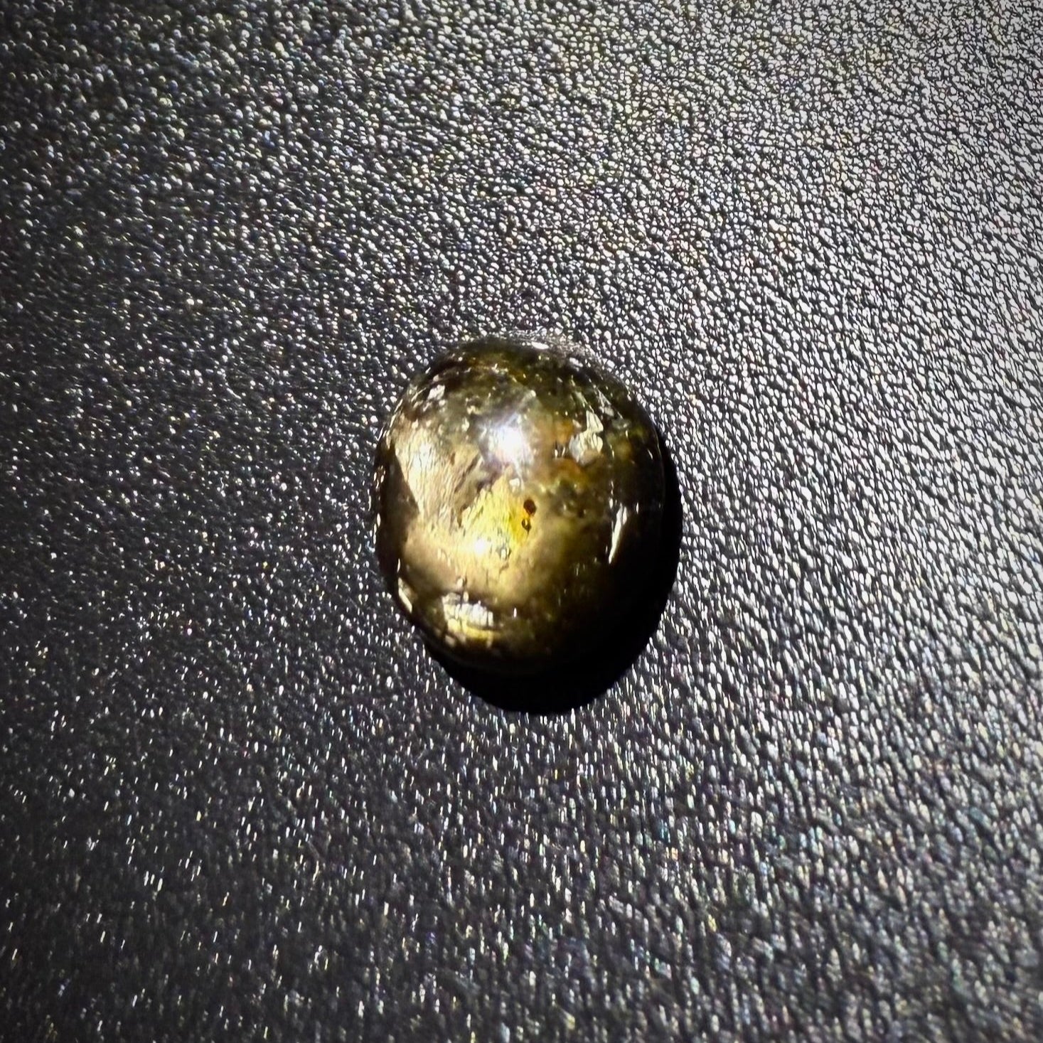 Golden-brown star sapphire cabochon, natural gemstone with subtle asterism