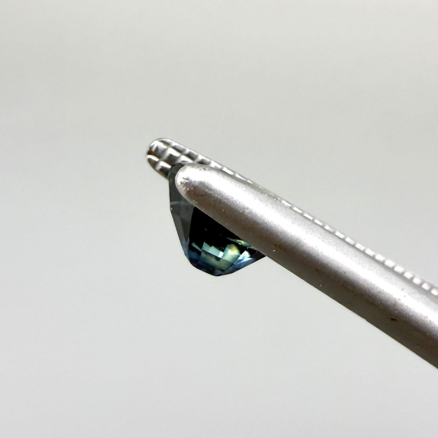 0.71 ct natural bi-color blue and yellow sapphire from Bangkaja, cushion cut.