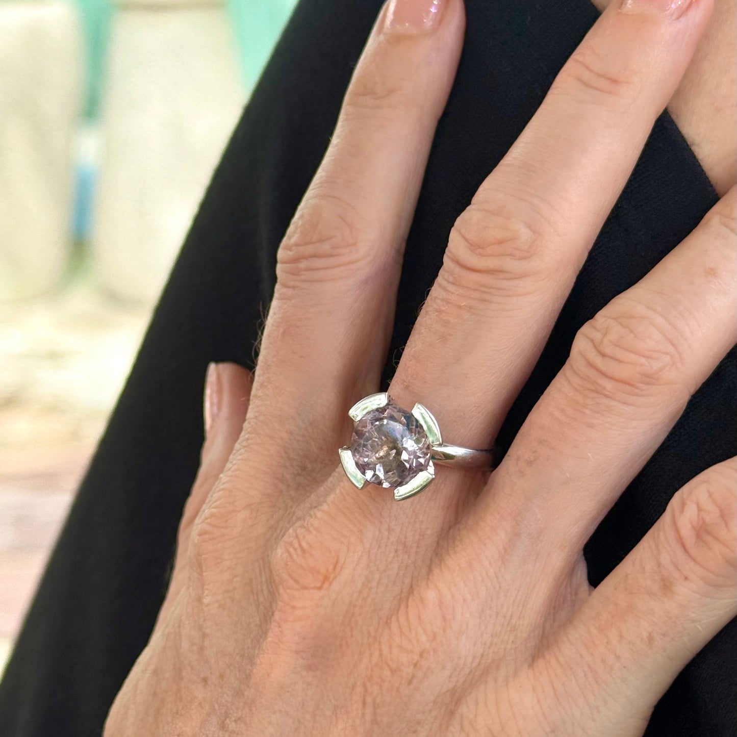 Handmade amethyst ring worn on hand, elegant and luminous design