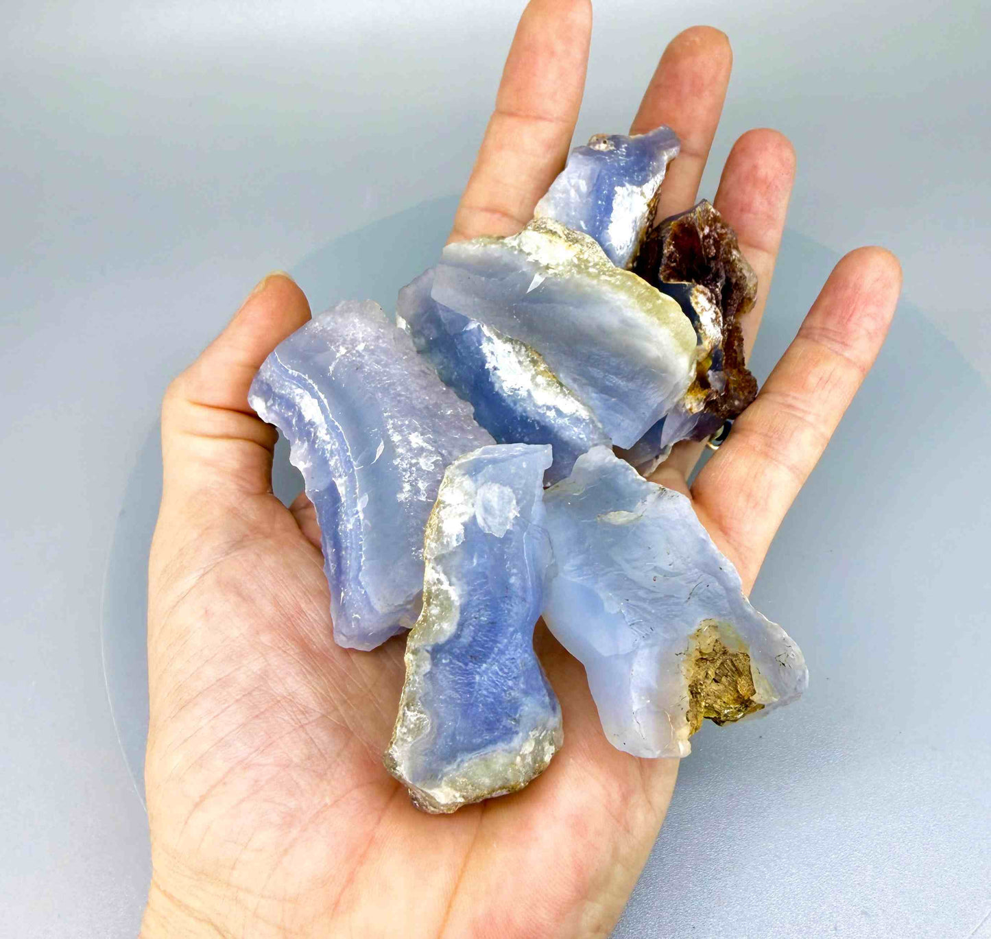 Untreated blue chalcedony rough lot with milky texture and natural blue banding
