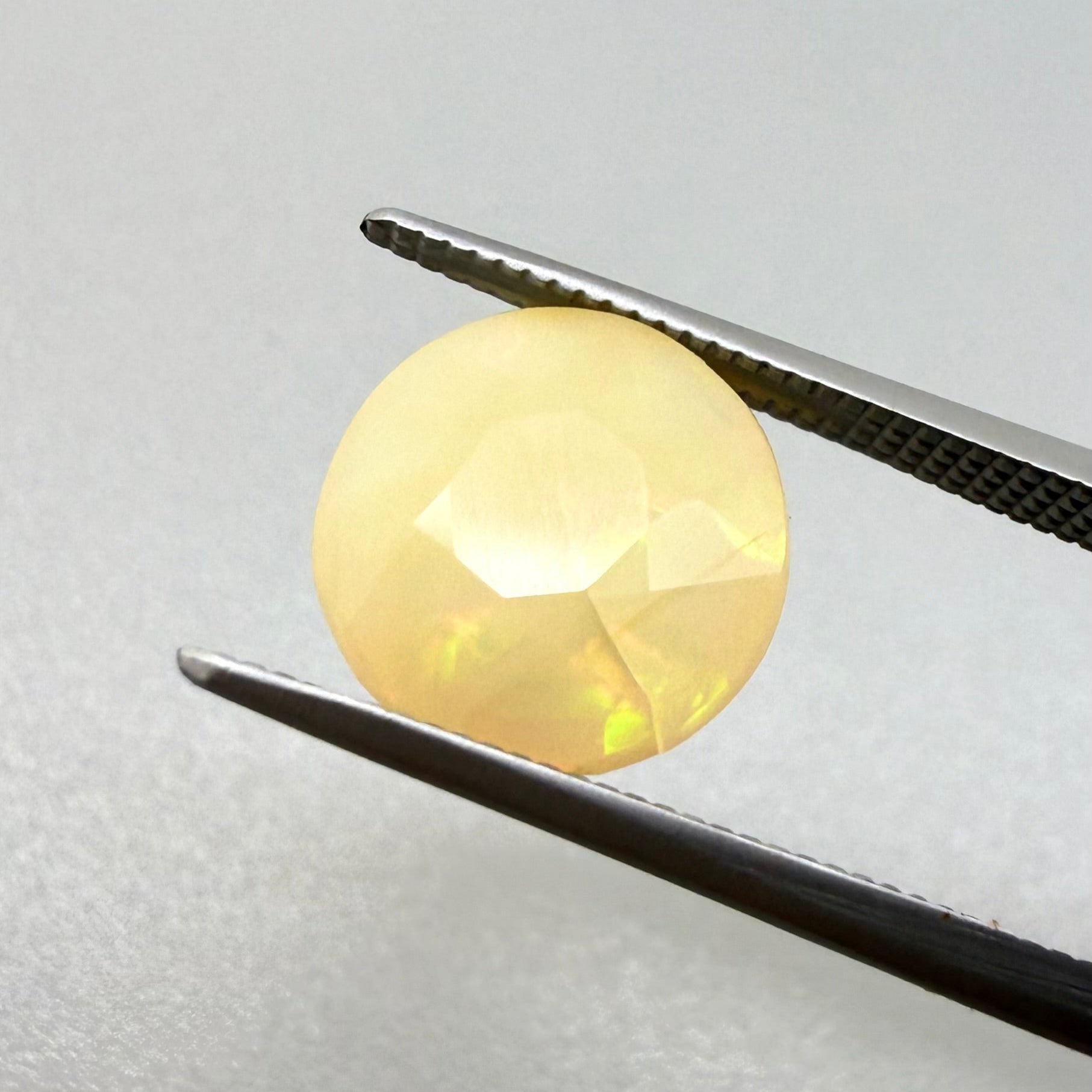 Natural Play-of-Color Fire Opal gemstone, round cut