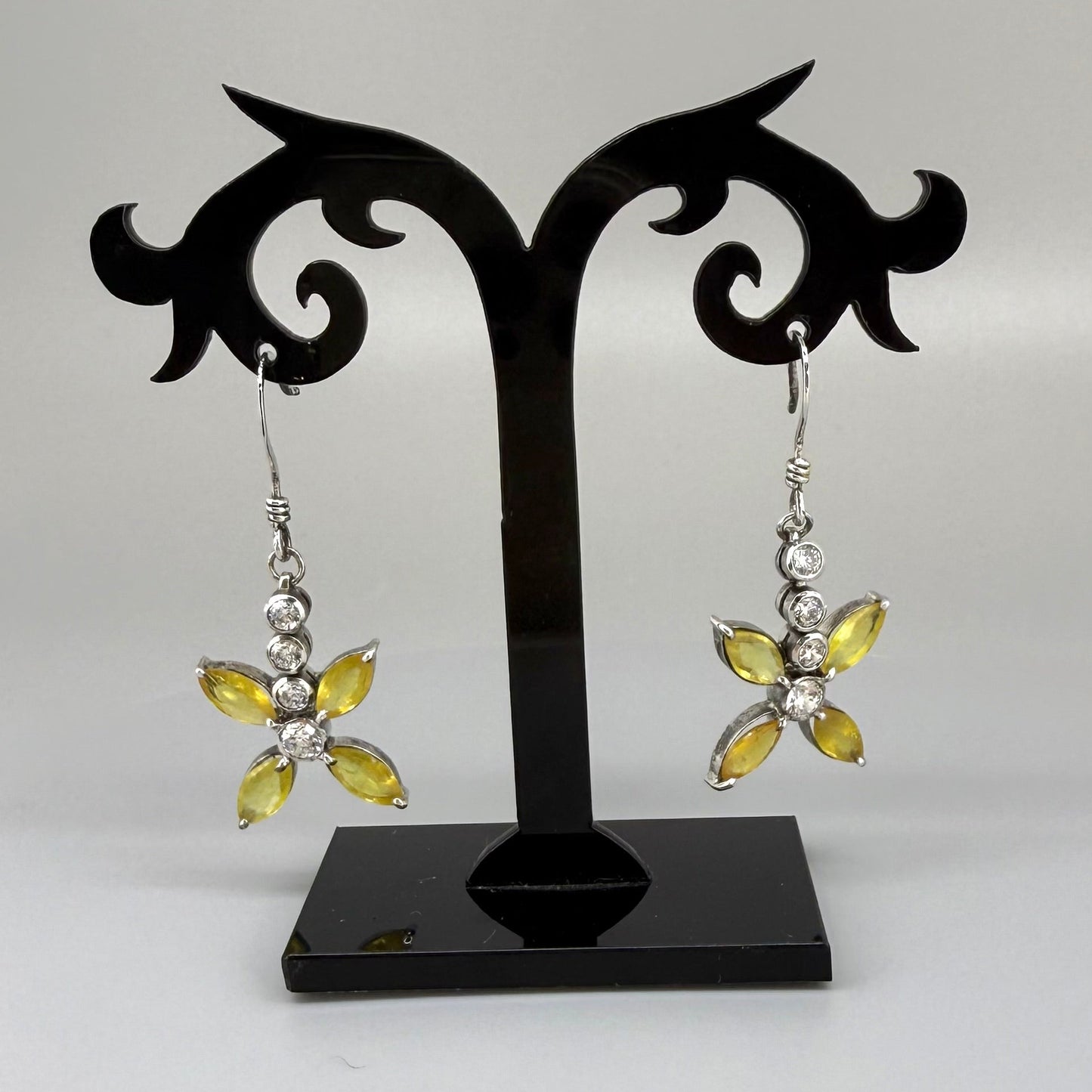Sterling silver drop earrings with yellow sapphires and cubic zirconia in a floral design, linked to the Sapphire Jewelry Collection.