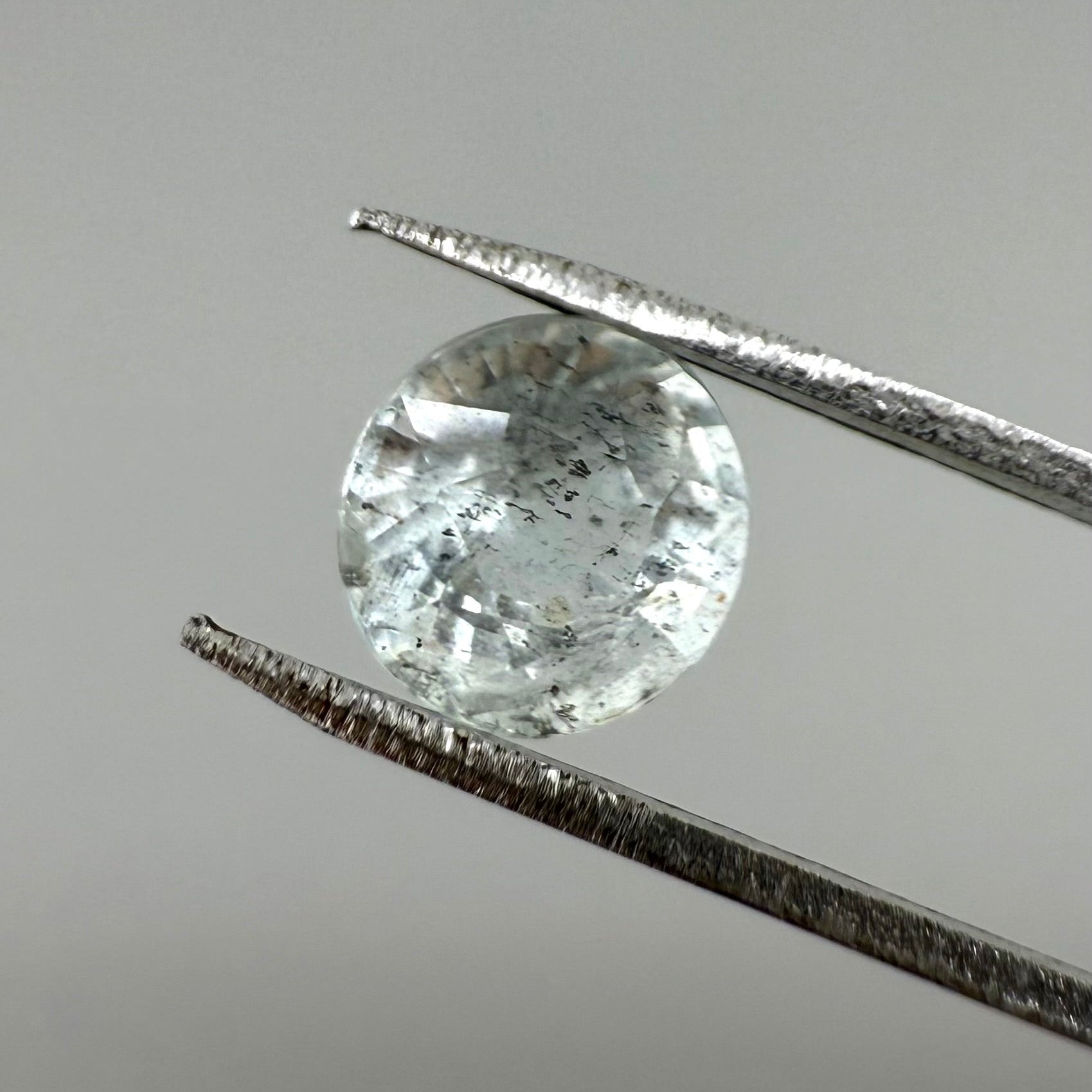 Natural Pale Blue Aquamarine gemstone, salt-and-pepper optic, round cut