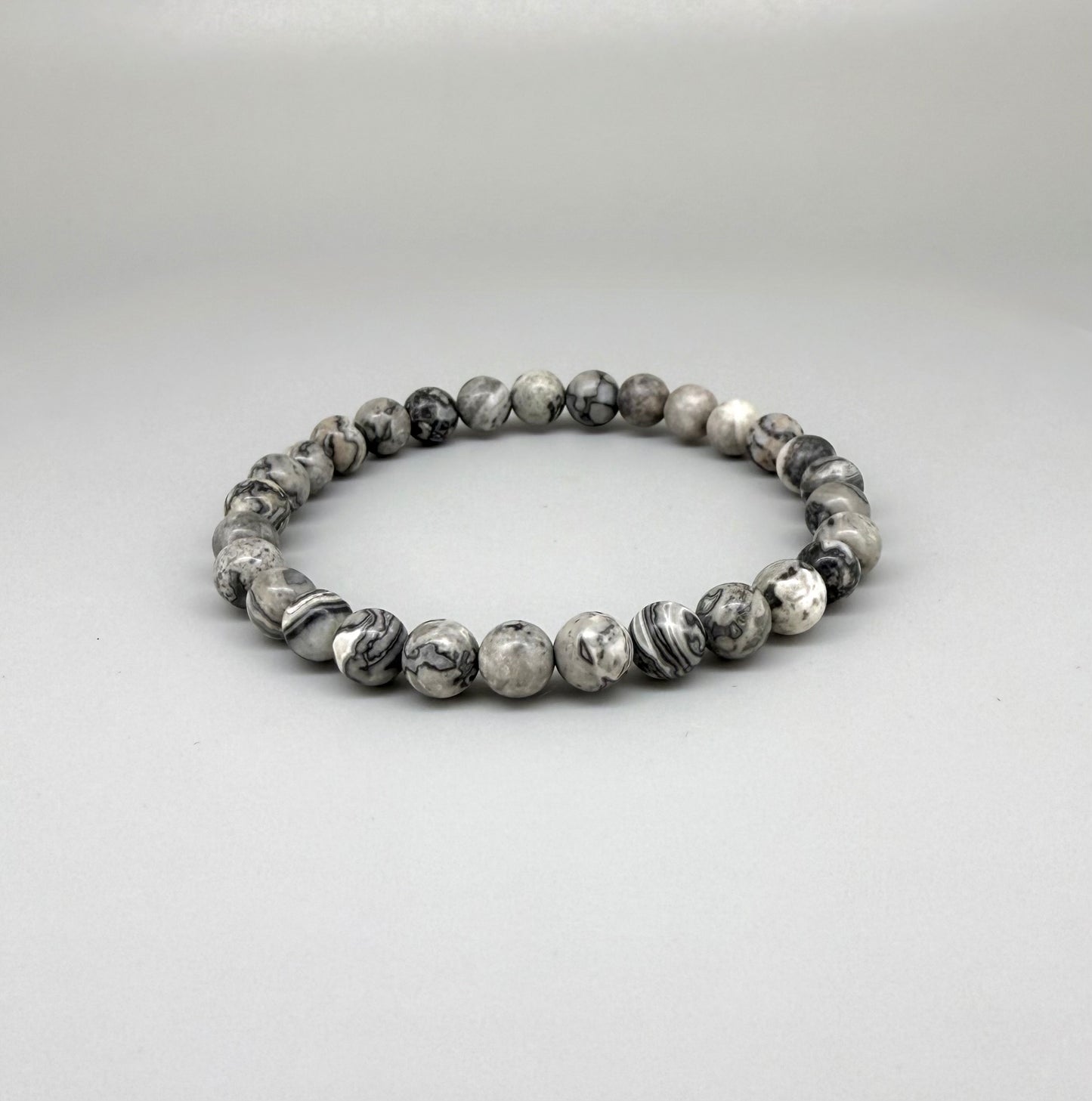 Jasper beaded bracelet, natural grey, black, and white marbled gemstone beads on elastic stretch band.