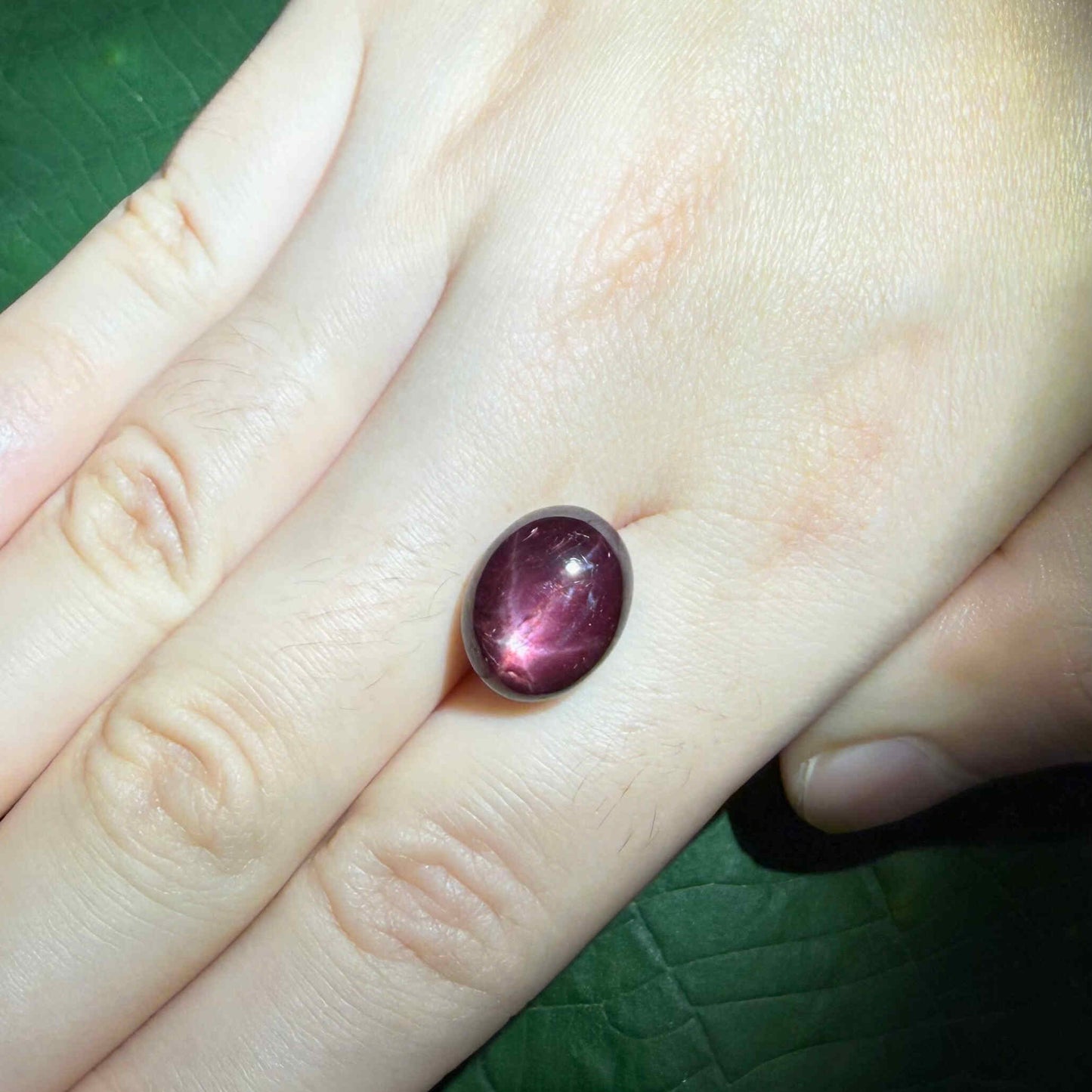 11.4 ct natural wine-red Star Ruby cabochon from Mozambique with soft star effect and polished dome.