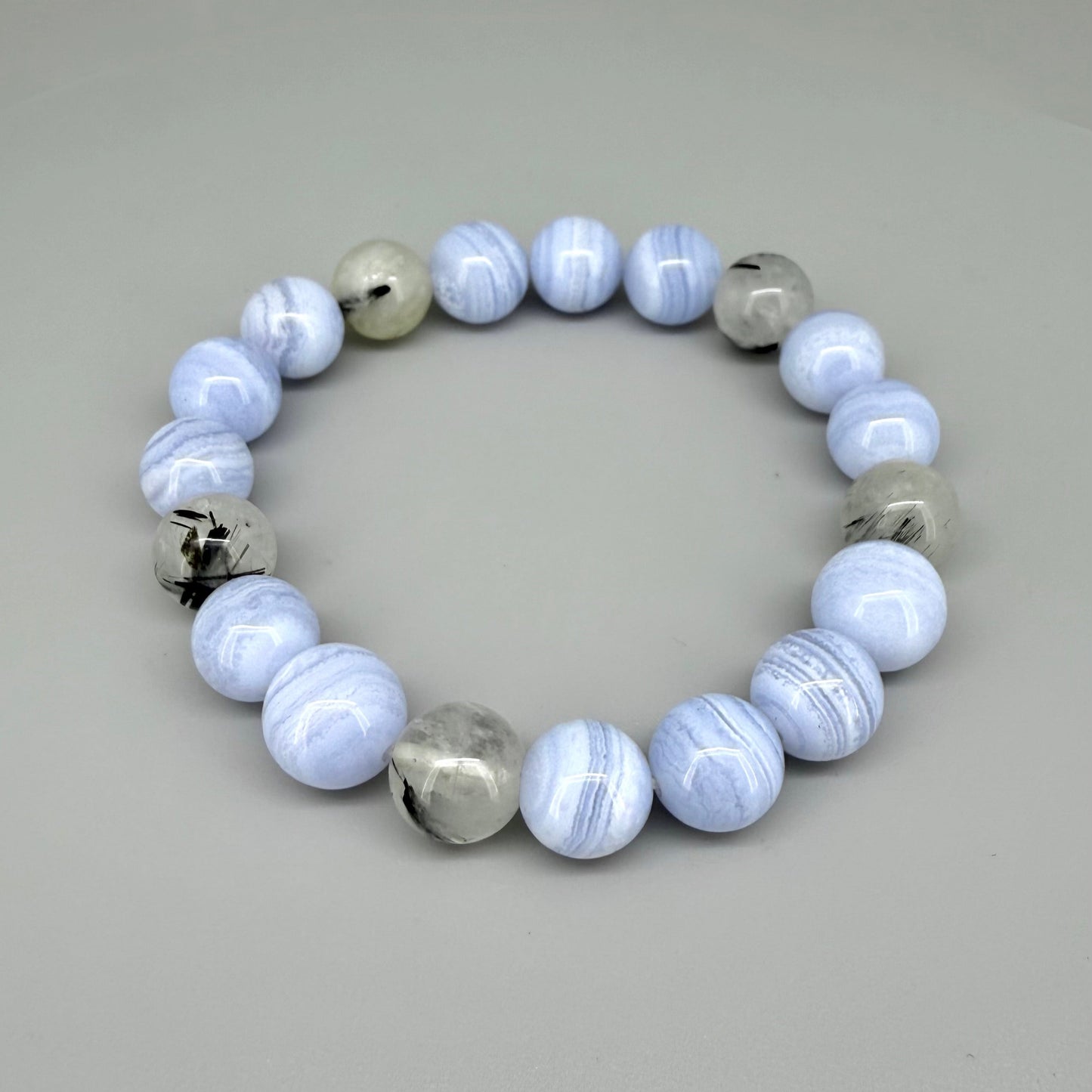 Chalcedony and rutilated quartz beaded bracelet, 18cm, light blue and grey gemstone beads with rutile inclusions on elastic stretch band.