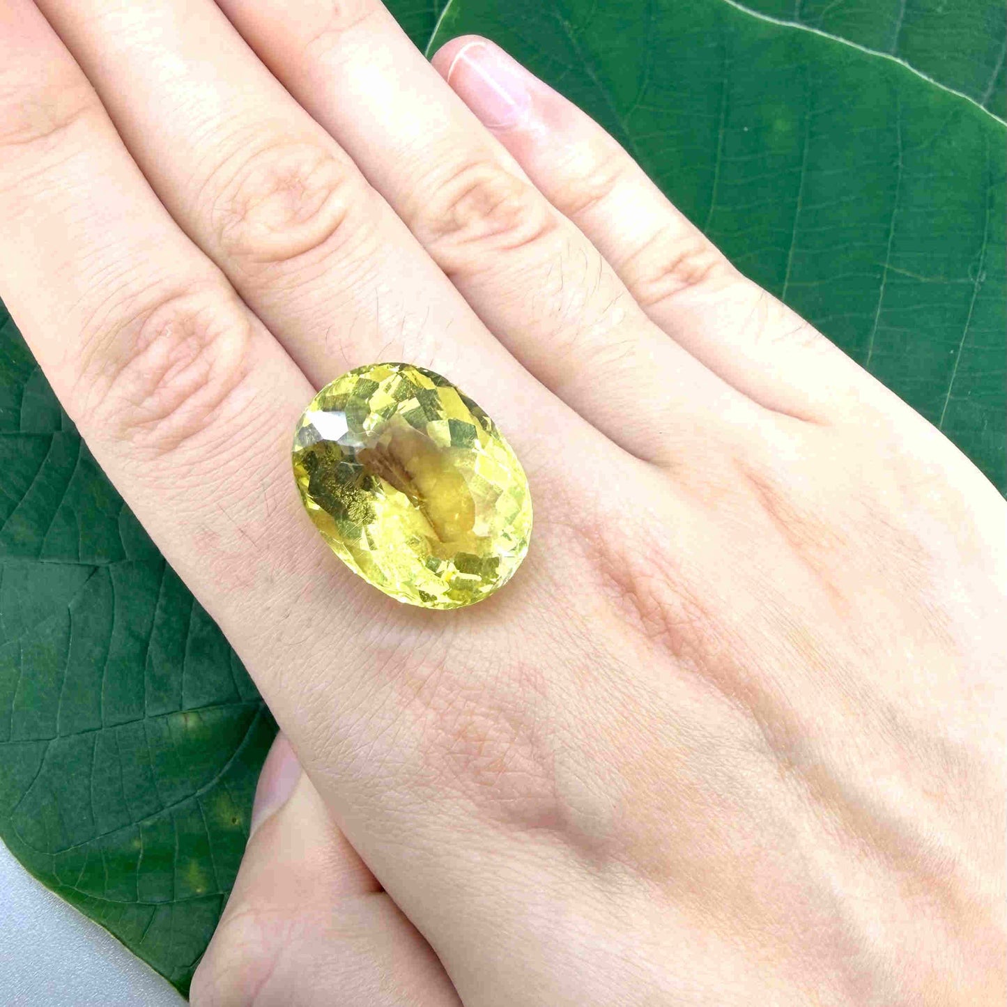 28.09 ct natural lemon quartz from Africa, oval cut with bright yellow color.