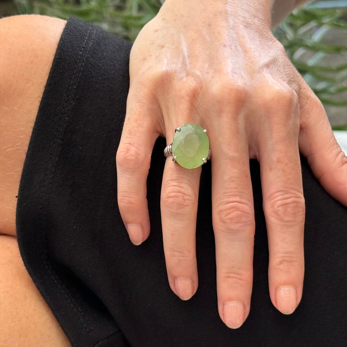 White gold plated sterling silver ring featuring an oval green quartz gemstone, elegant solitaire design with soft natural color.