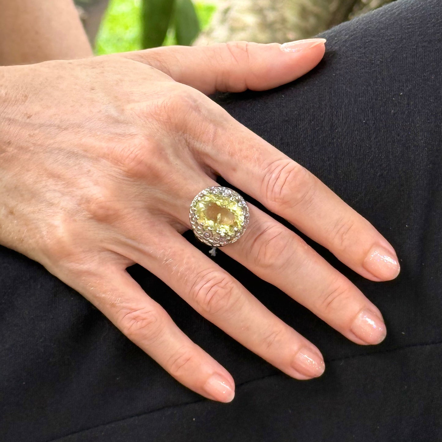 Statement ring with oval lemon quartz set in white gold plated sterling silver featuring intricate silver details and radiant yellow tones.