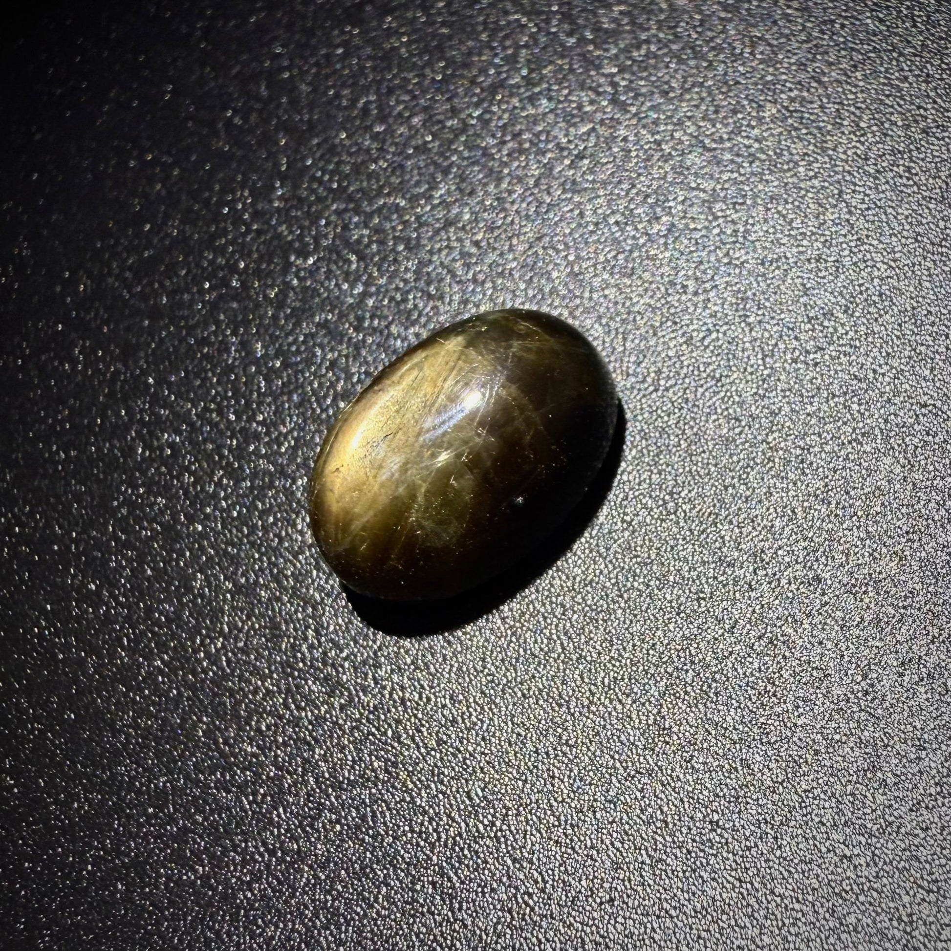 Golden-brown star sapphire cabochon, natural gemstone with subtle asterism