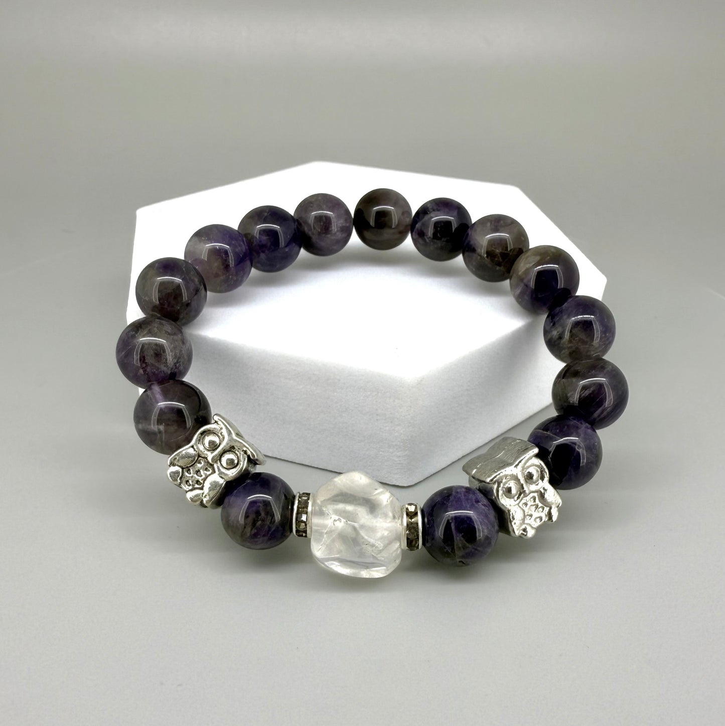 Amethyst beaded bracelet, 18cm, violet gemstone beads with large clear white focal stone and two owl accents on elastic stretch band.
