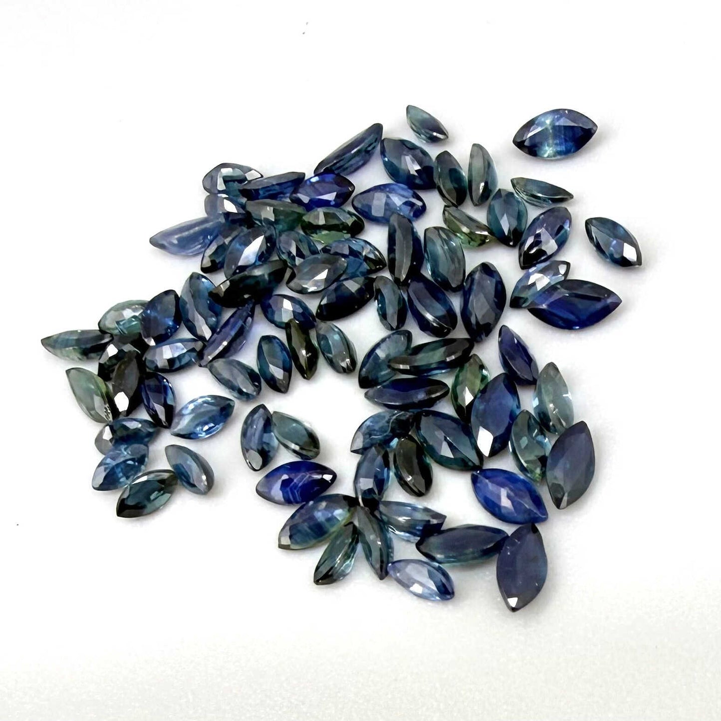 13.2 ct natural sapphire lot from Thailand, marquise cut stones in mid-to-dark vibrant blue hues.