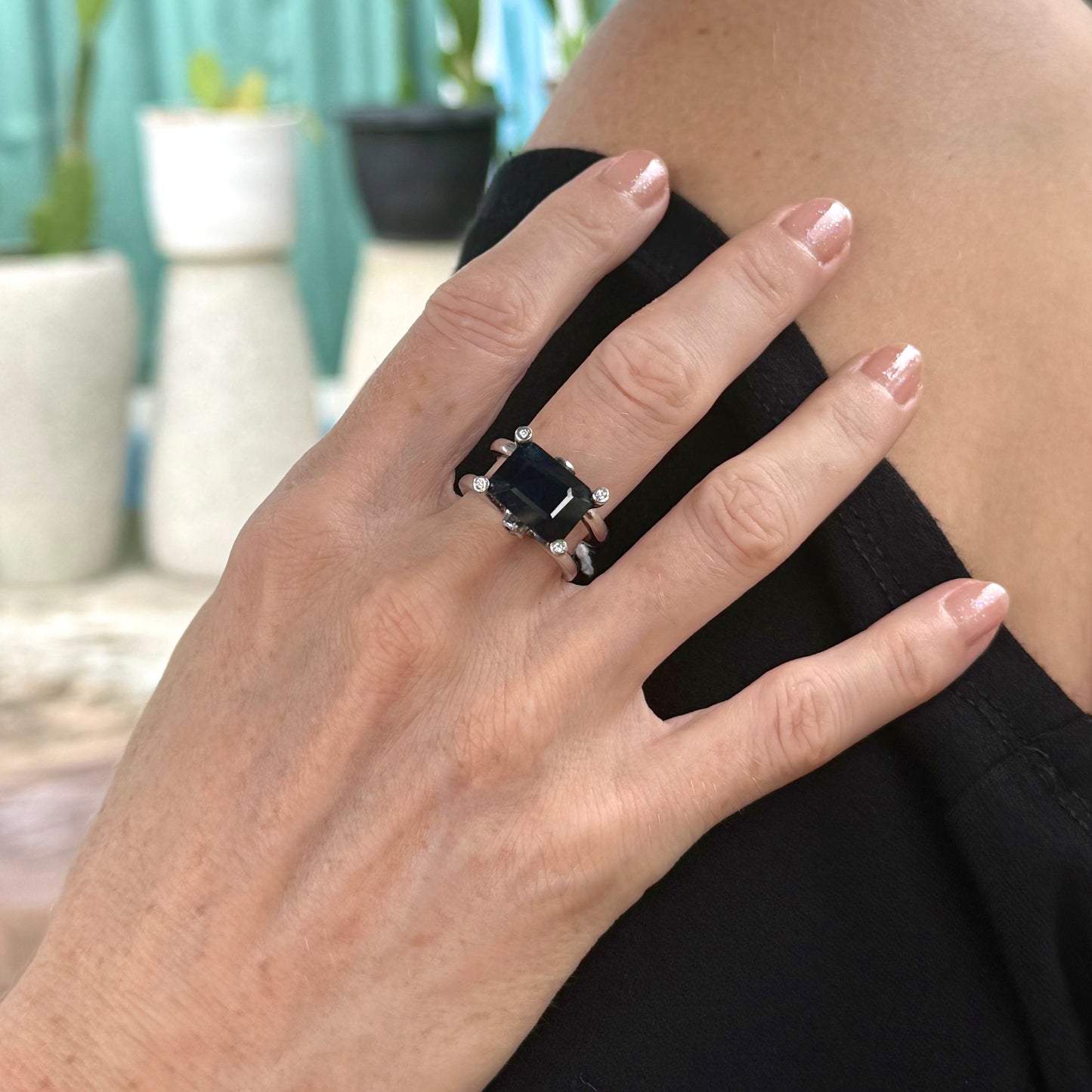 Emerald-cut sapphire ring in white gold plated sterling silver, featuring a natural deep blue gemstone in a bold and elegant solitaire design.
