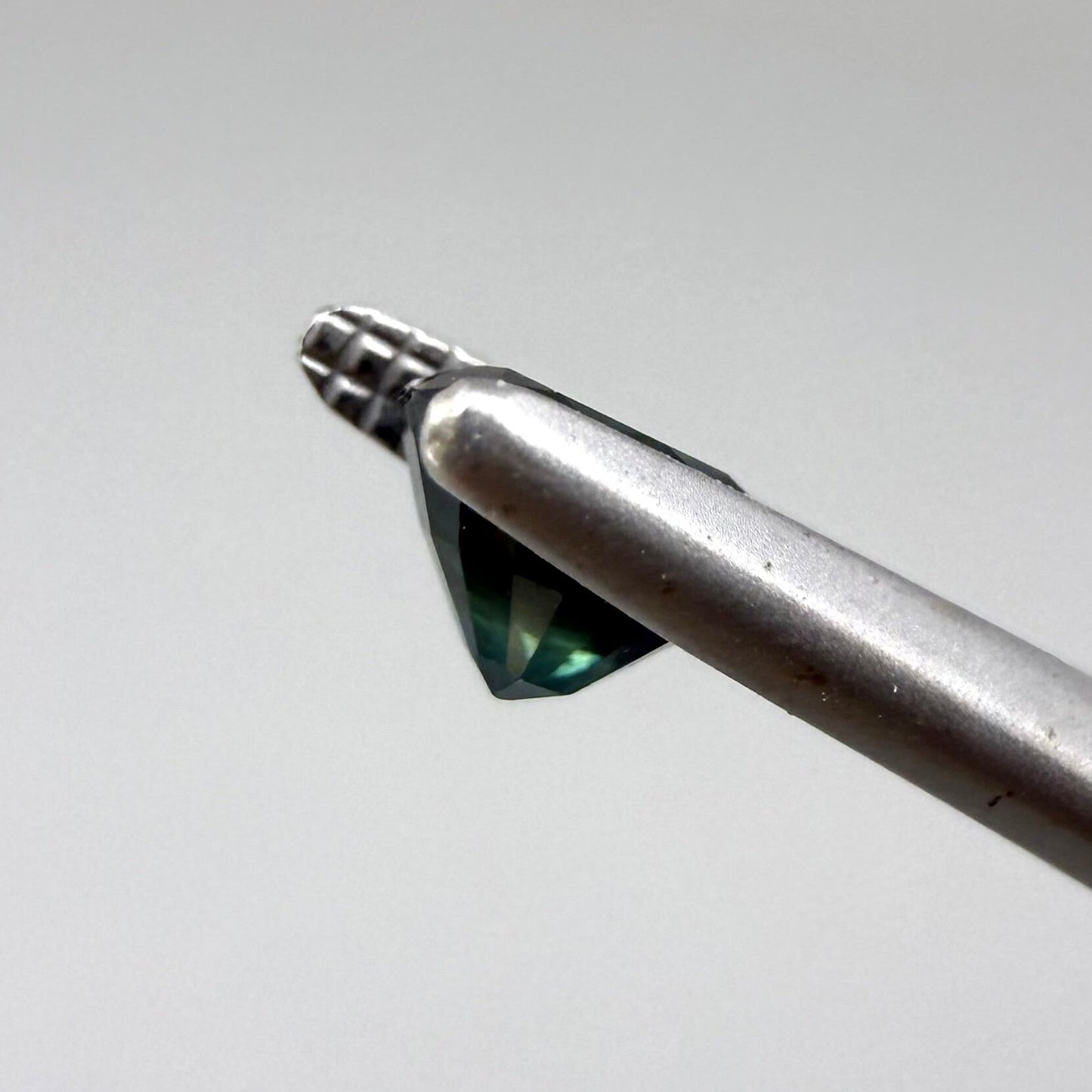 0.67 ct natural blue-green sapphire from Bangkaja, faceted cut.