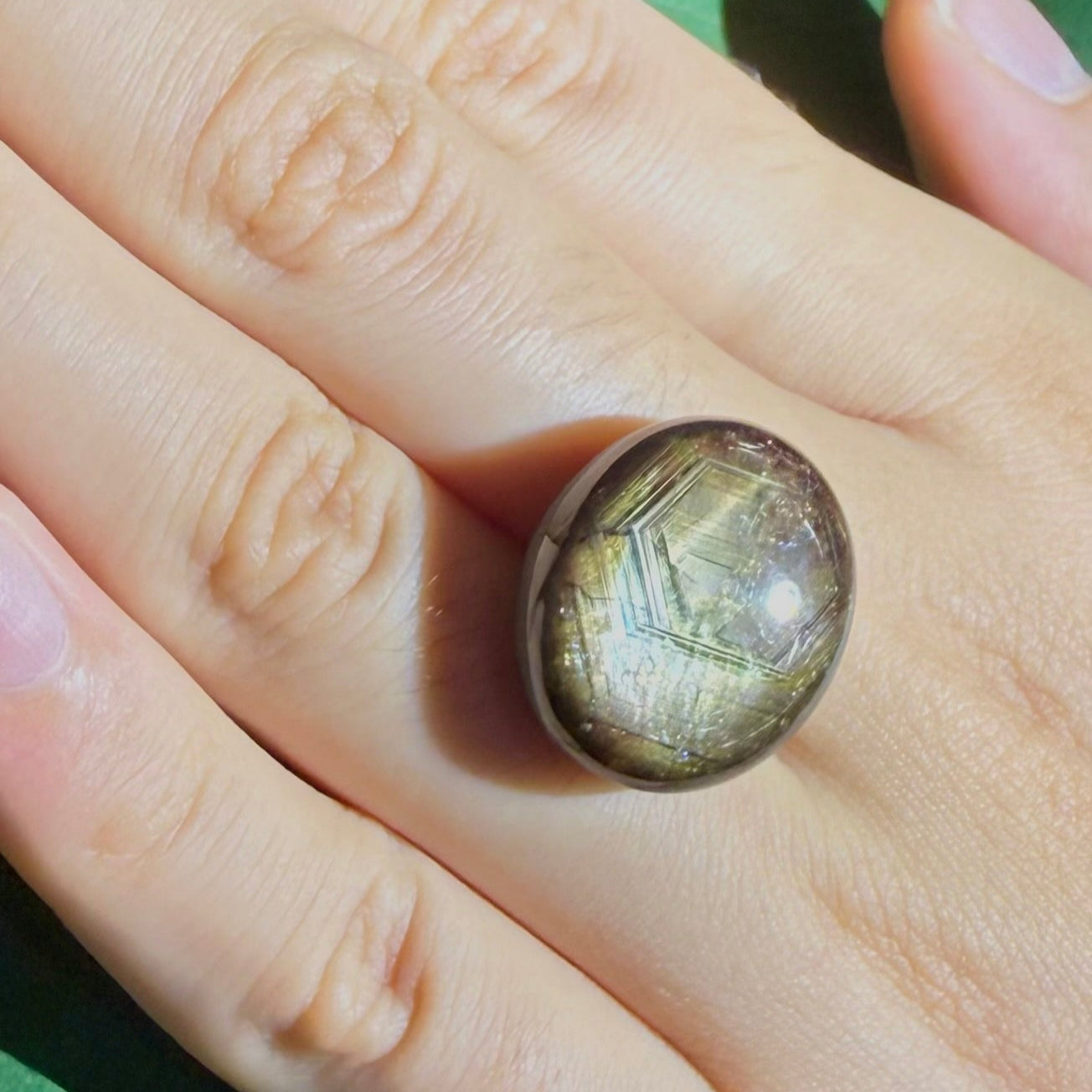 Golden-brown star sapphire cabochon, natural gemstone with subtle asterism