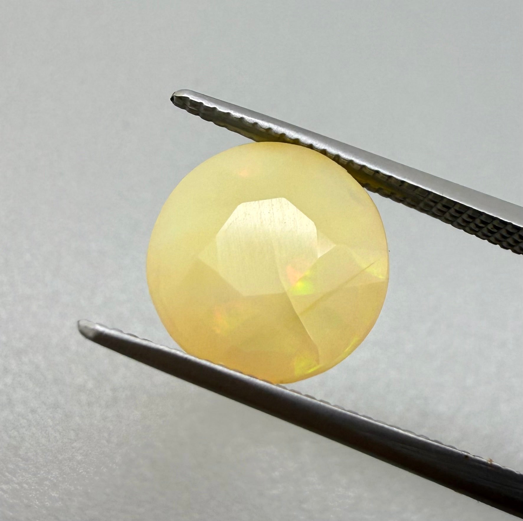 Natural Play-of-Color Fire Opal gemstone, round cut