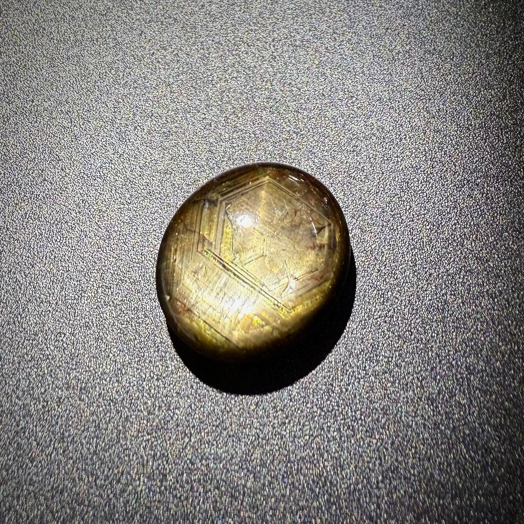 Golden-brown star sapphire cabochon, natural gemstone with subtle asterism