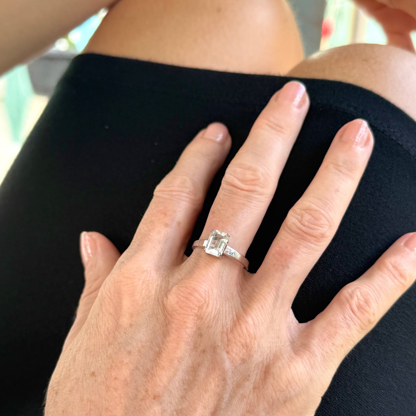 Aquamarine solitaire ring in white gold plated sterling silver, featuring a light blue natural gemstone on neutral background, elegant and timeless design.