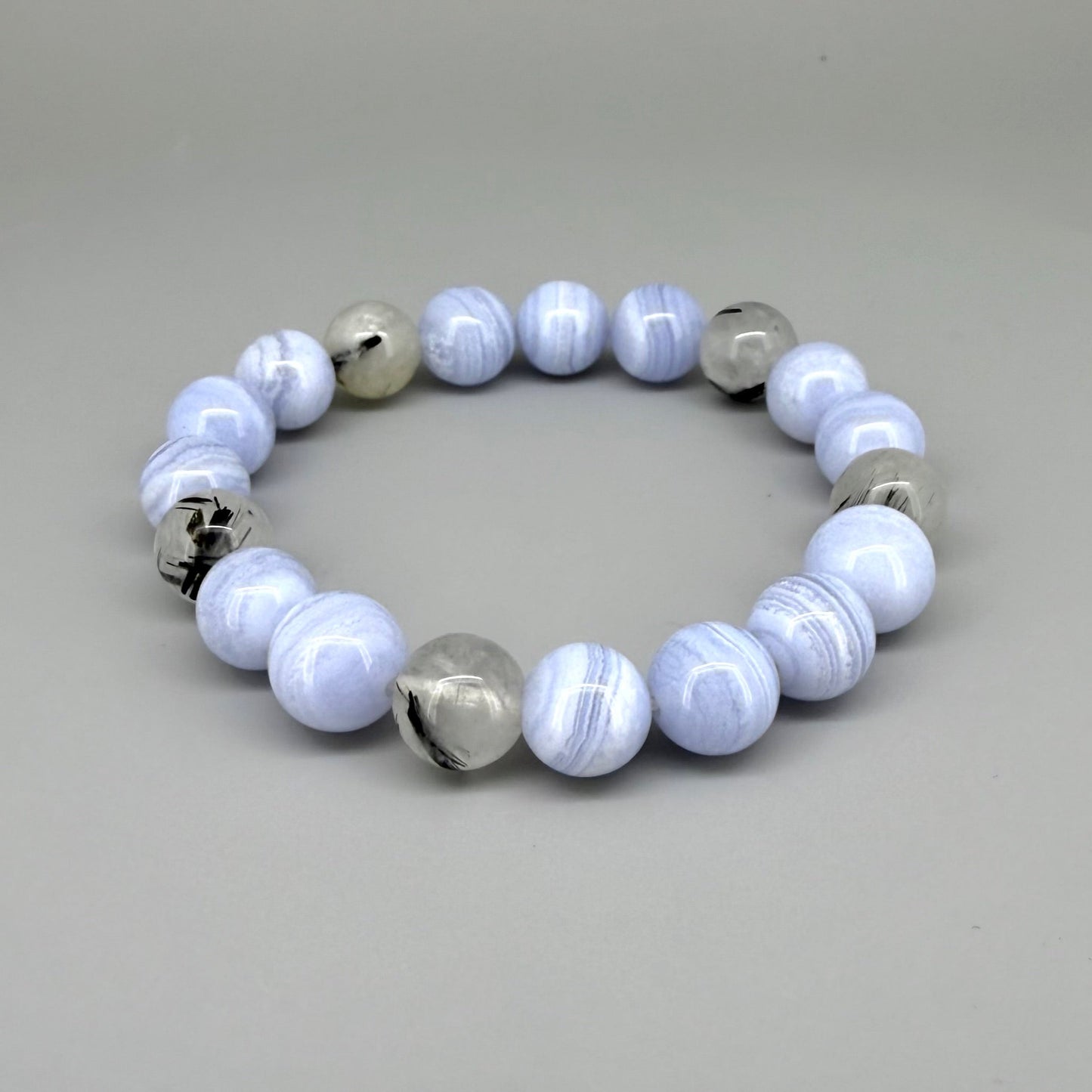 Chalcedony and rutilated quartz beaded bracelet, 18cm, light blue and grey gemstone beads with rutile inclusions on elastic stretch band.