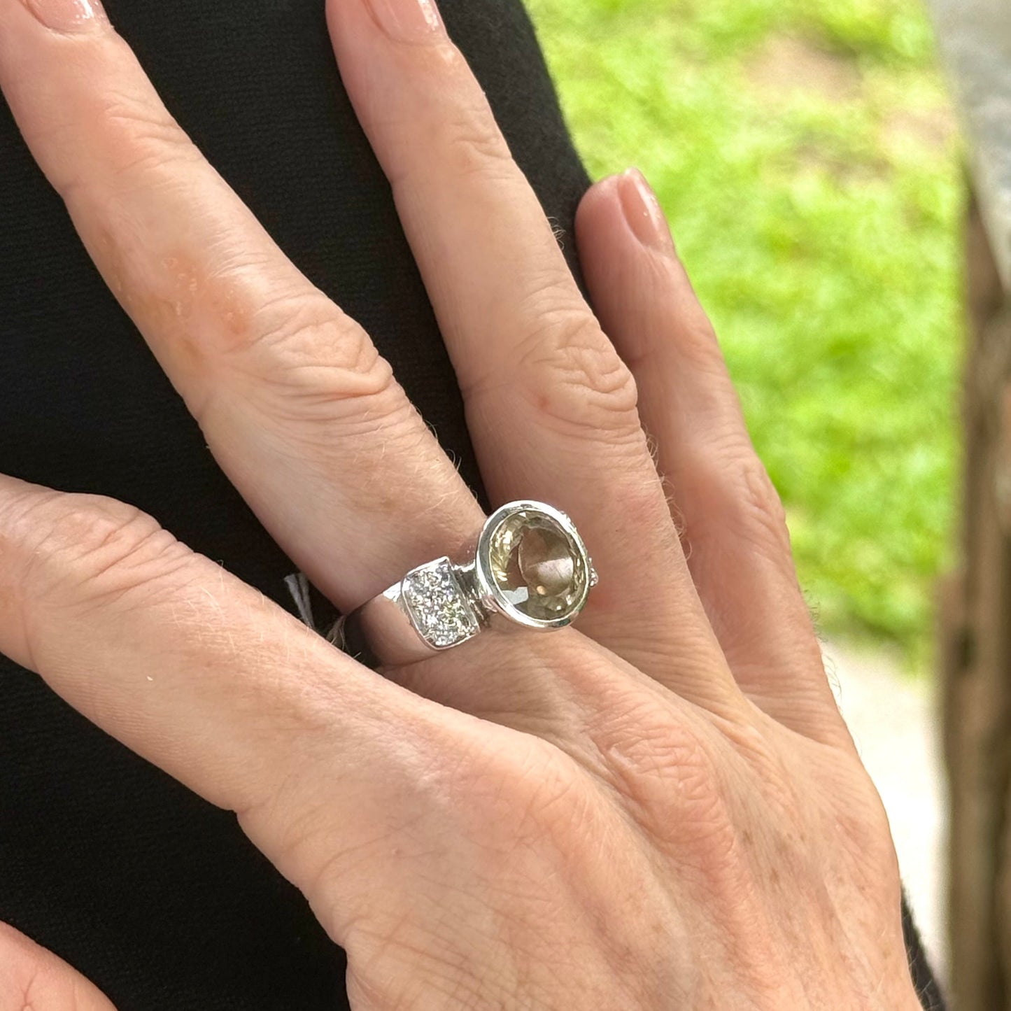 Citrine and CZ ring in white gold plated sterling silver, featuring a faceted golden gemstone with sparkling accents along the band, elegant and radiant design.