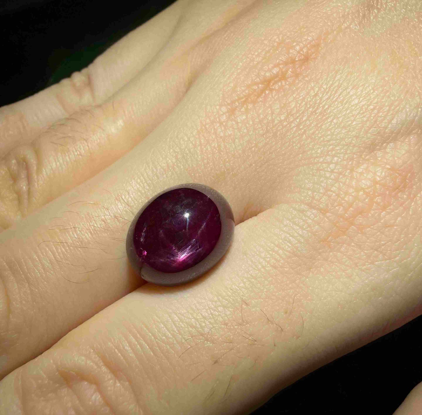 13.5 ct natural Pink-Red Star Ruby cabochon from Mozambique with soft star effect and polished dome.