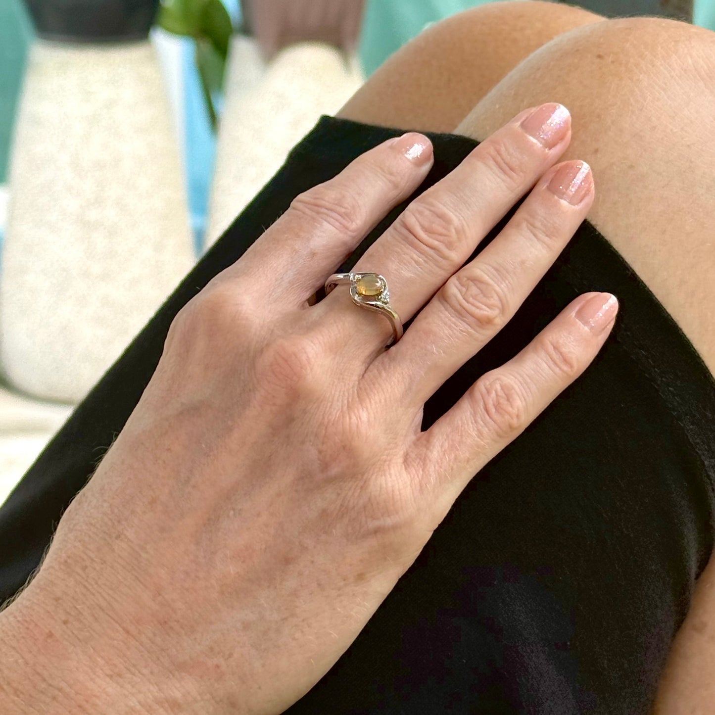 Opal solitaire ring in white gold plated sterling silver, featuring a natural gemstone with yellow hues, elegant and timeless design.