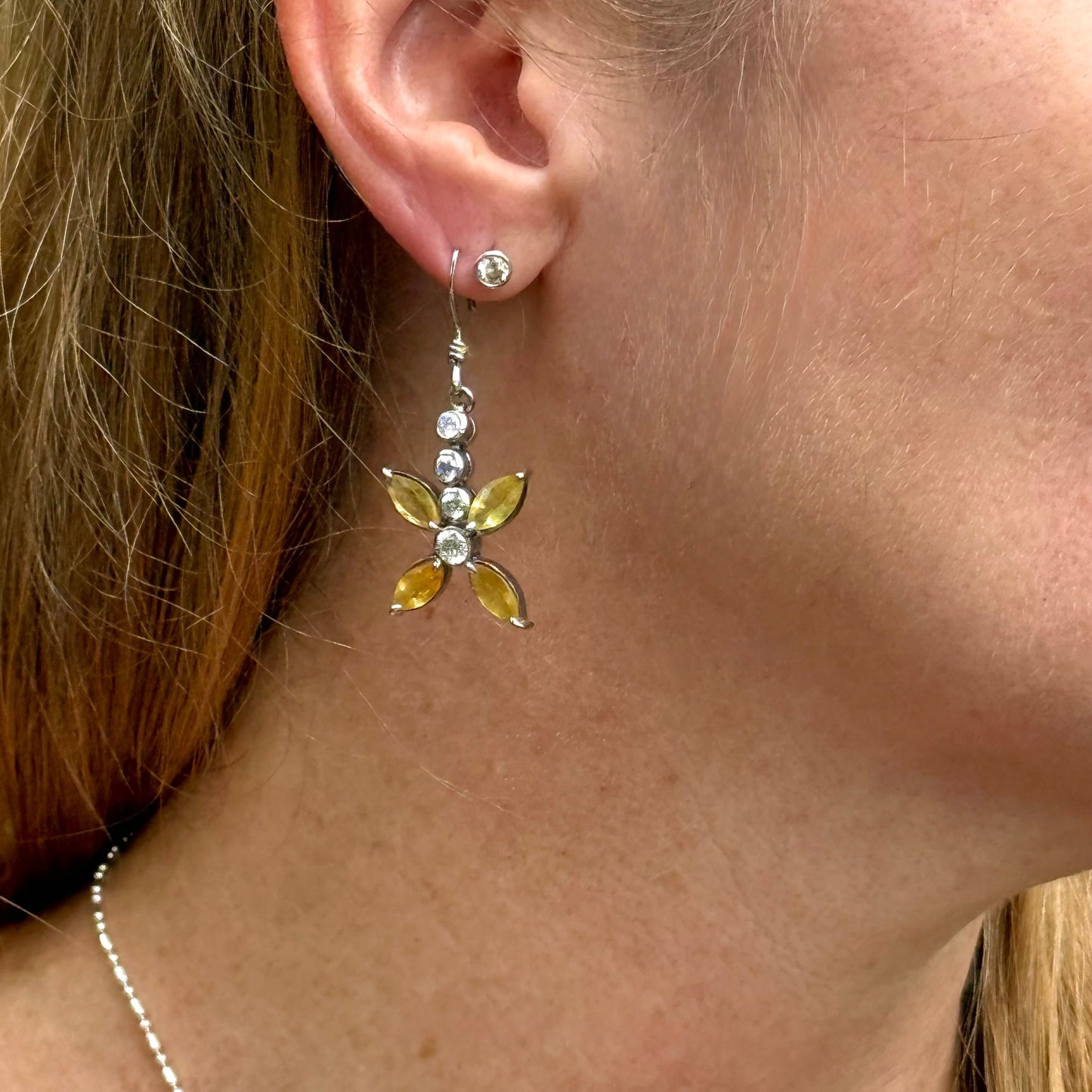 Sterling silver drop earrings with yellow sapphires and cubic zirconia in a floral design, linked to the Sapphire Jewelry Collection.