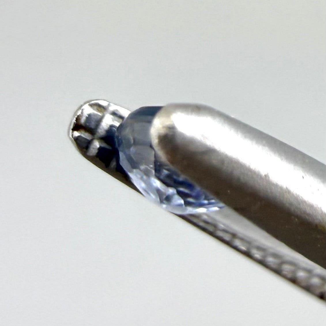 0.2 ct natural blue sapphire with visible color inclusion pattern, round cut.