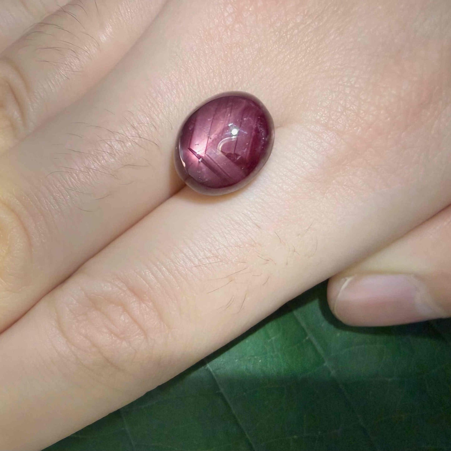 14.4 ct natural Pink-Red Star Ruby cabochon from Mozambique with soft star effect and polished dome.