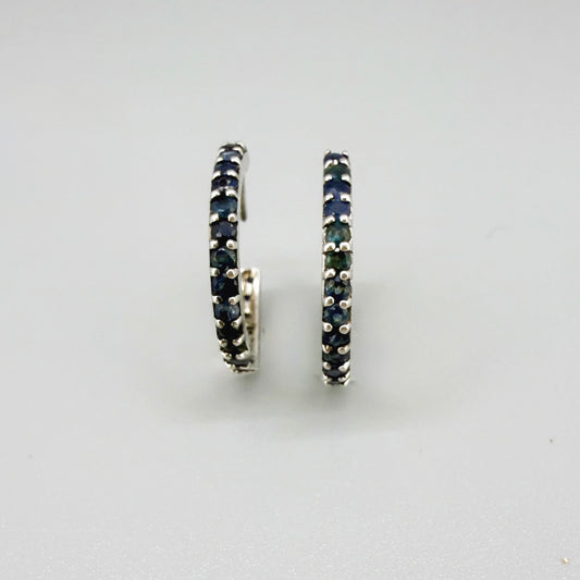 Elegant hoop earrings in white gold plated sterling silver set with natural blue sapphires.