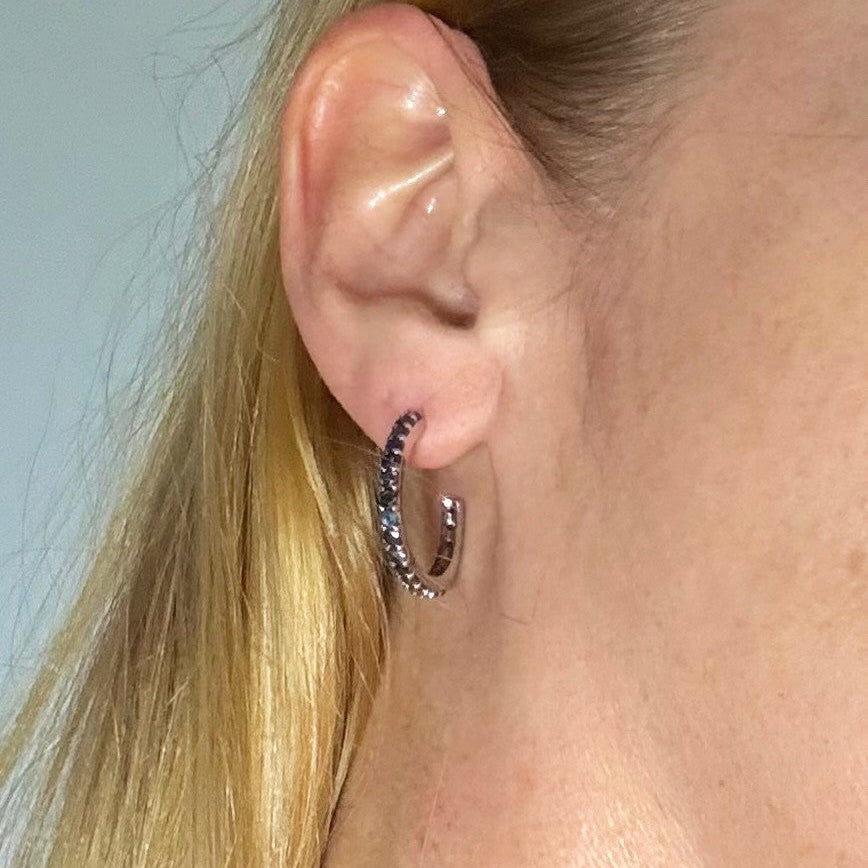 Elegant hoop earrings in white gold plated sterling silver set with natural blue sapphires.
