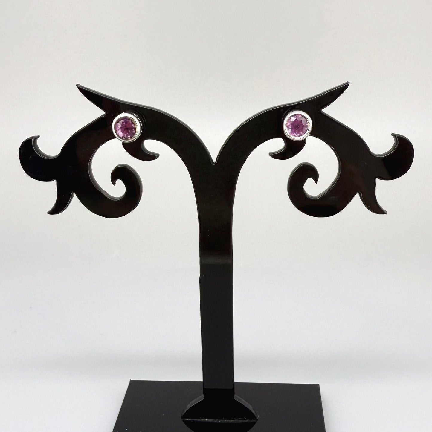 Rhodolite garnet stud earrings in white gold plated sterling silver with butterfly backs.