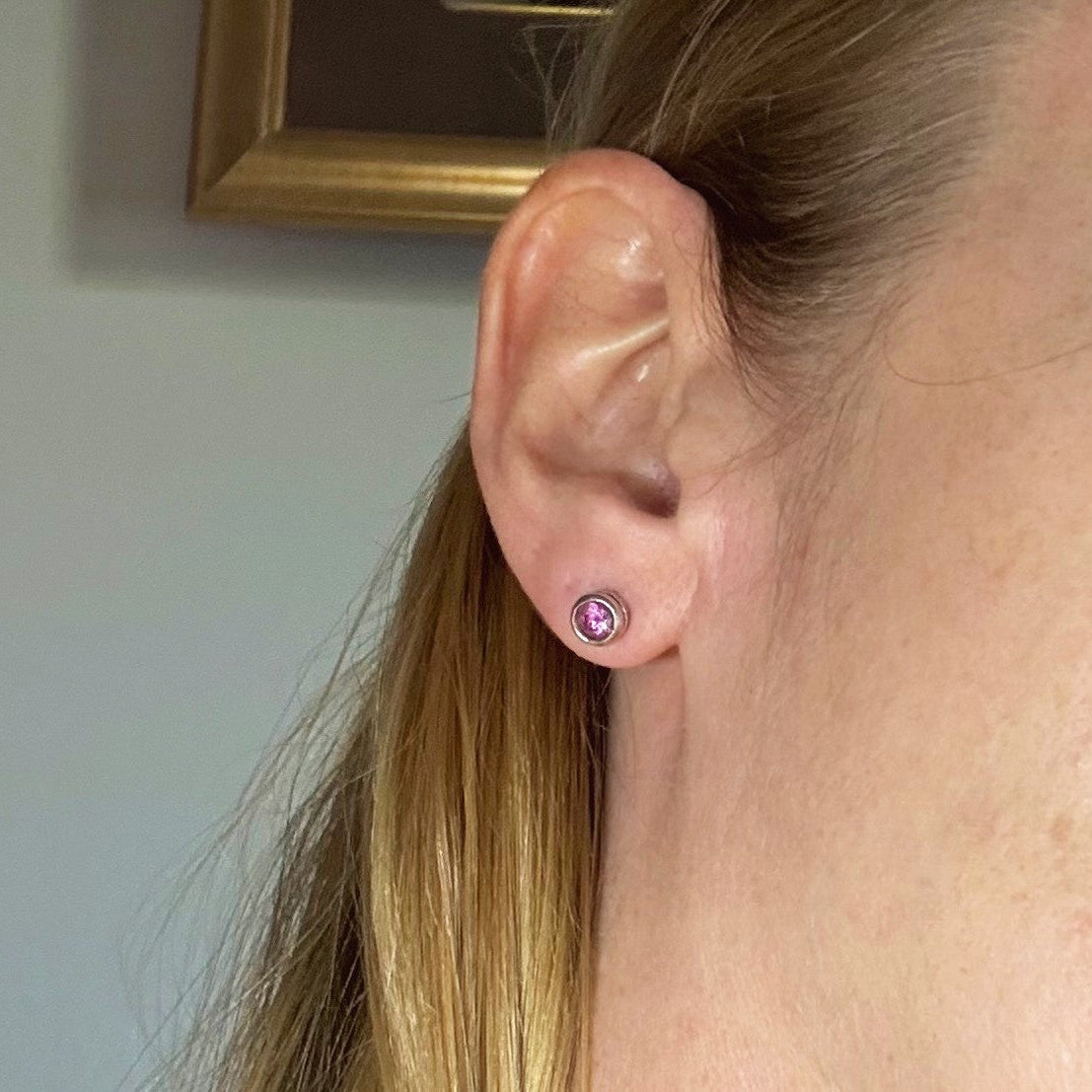 Rhodolite garnet stud earrings in white gold plated sterling silver with butterfly backs.