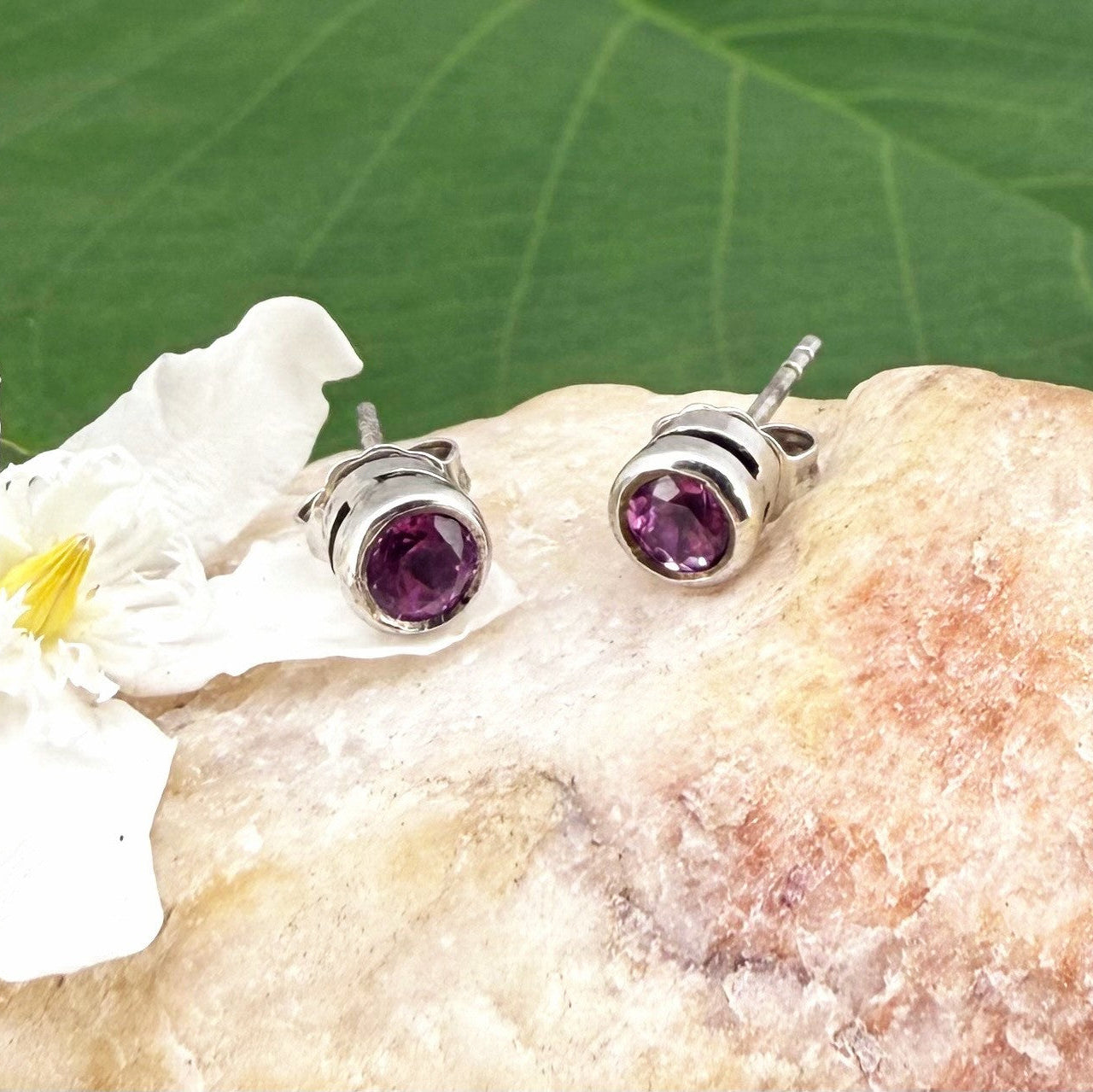 Rhodolite garnet stud earrings in white gold plated sterling silver with butterfly backs.