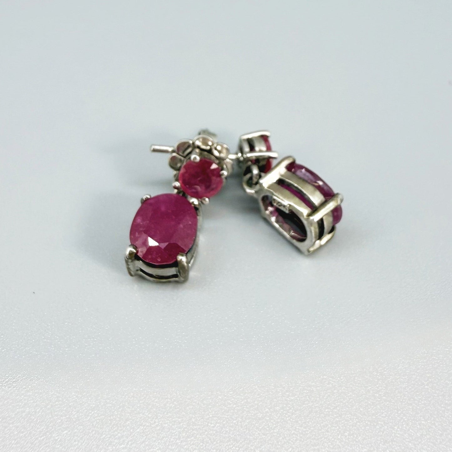 Ruby drop earrings in white gold plated sterling silver with natural pink rubies.