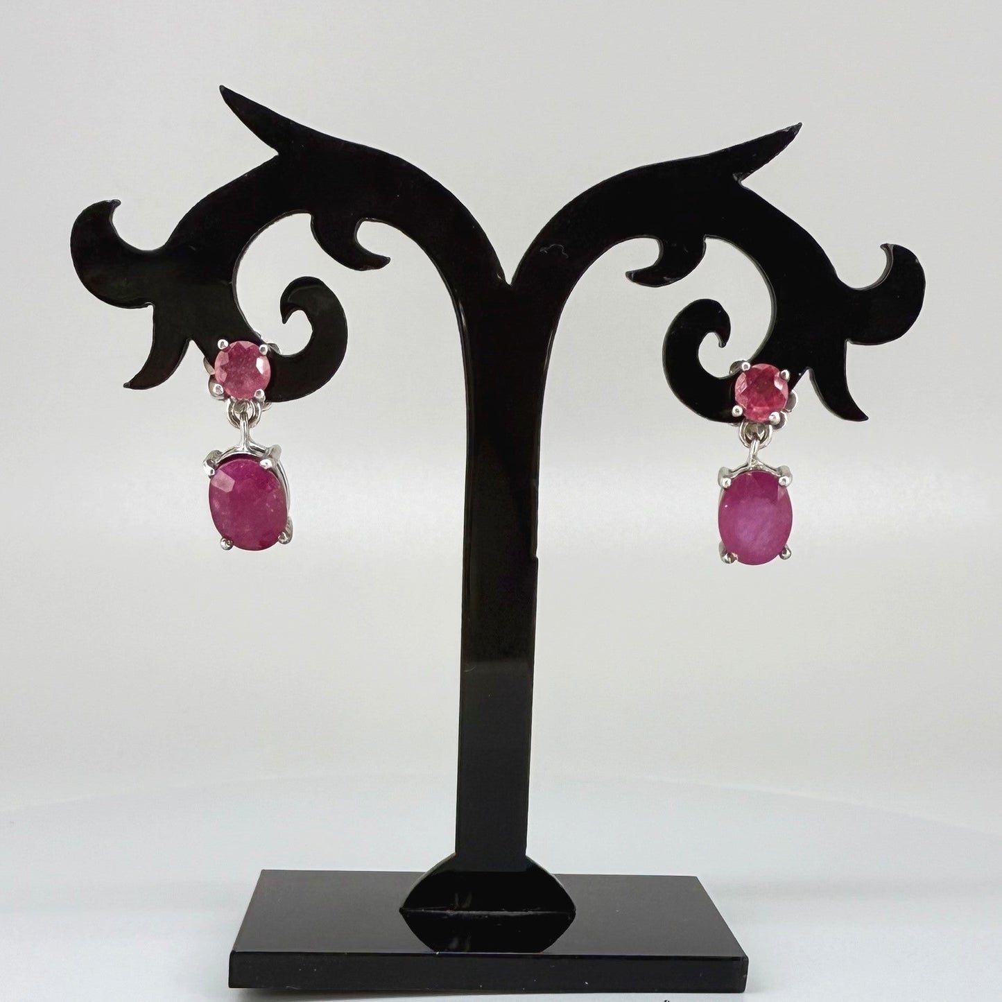 Ruby drop earrings in white gold plated sterling silver with natural pink rubies.
