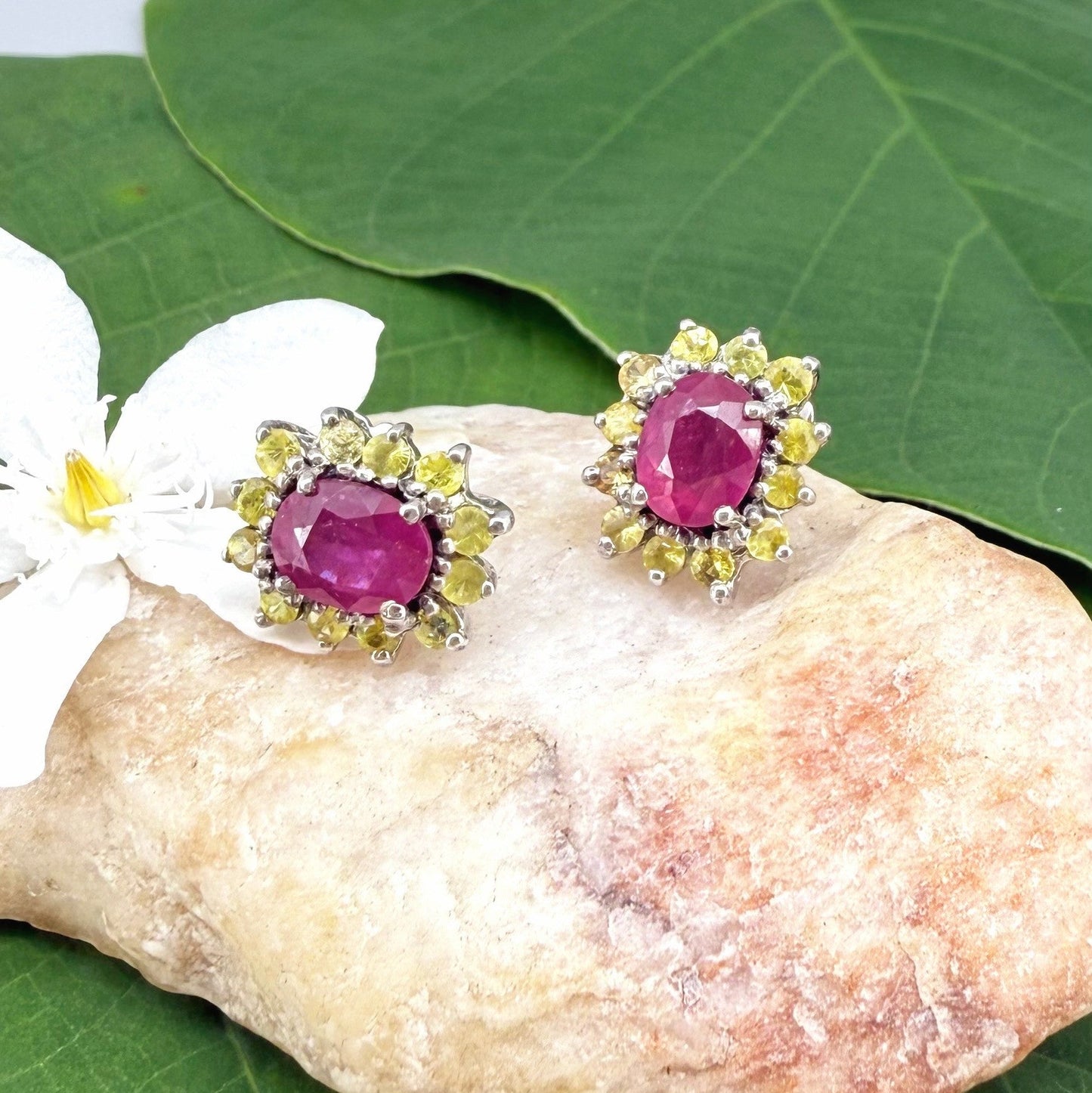 Ruby and yellow sapphire stud earrings in white gold plated sterling silver with butterfly backs.