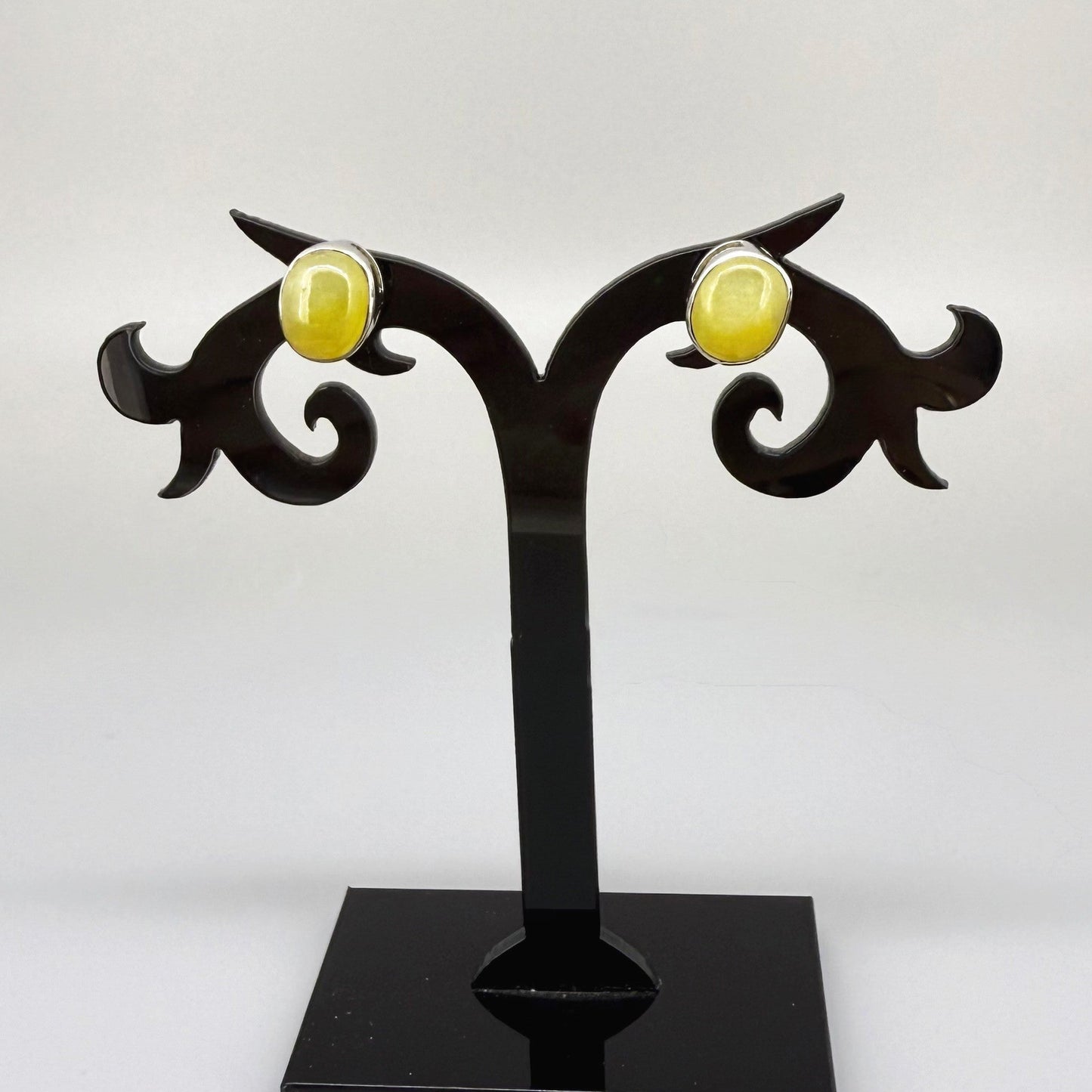 Yellow sapphire cabochon stud earrings in white gold plated sterling silver with butterfly backs.