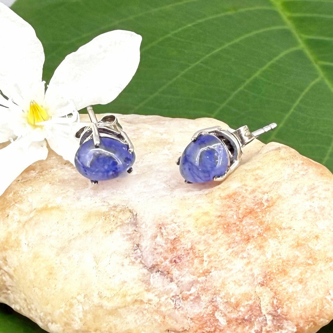 Sterling silver stud earrings with deep blue natural sapphires, plated in white gold for refined brilliance.